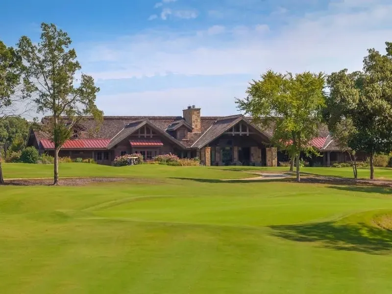 View of home's community featuring golf course view and a lawn