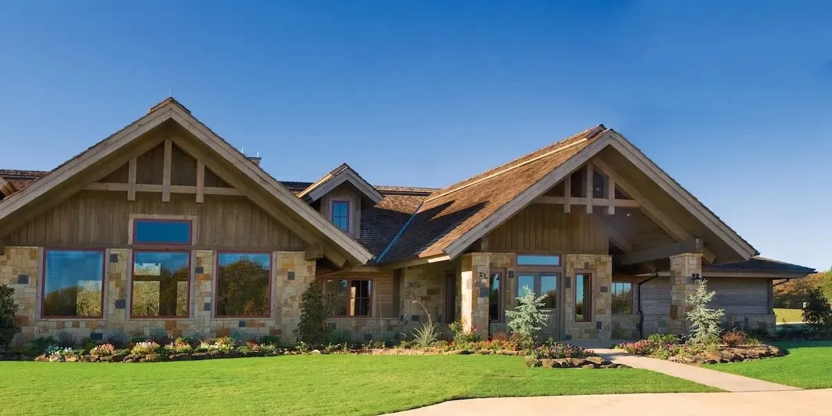 View of front of house featuring stone siding and a front yard