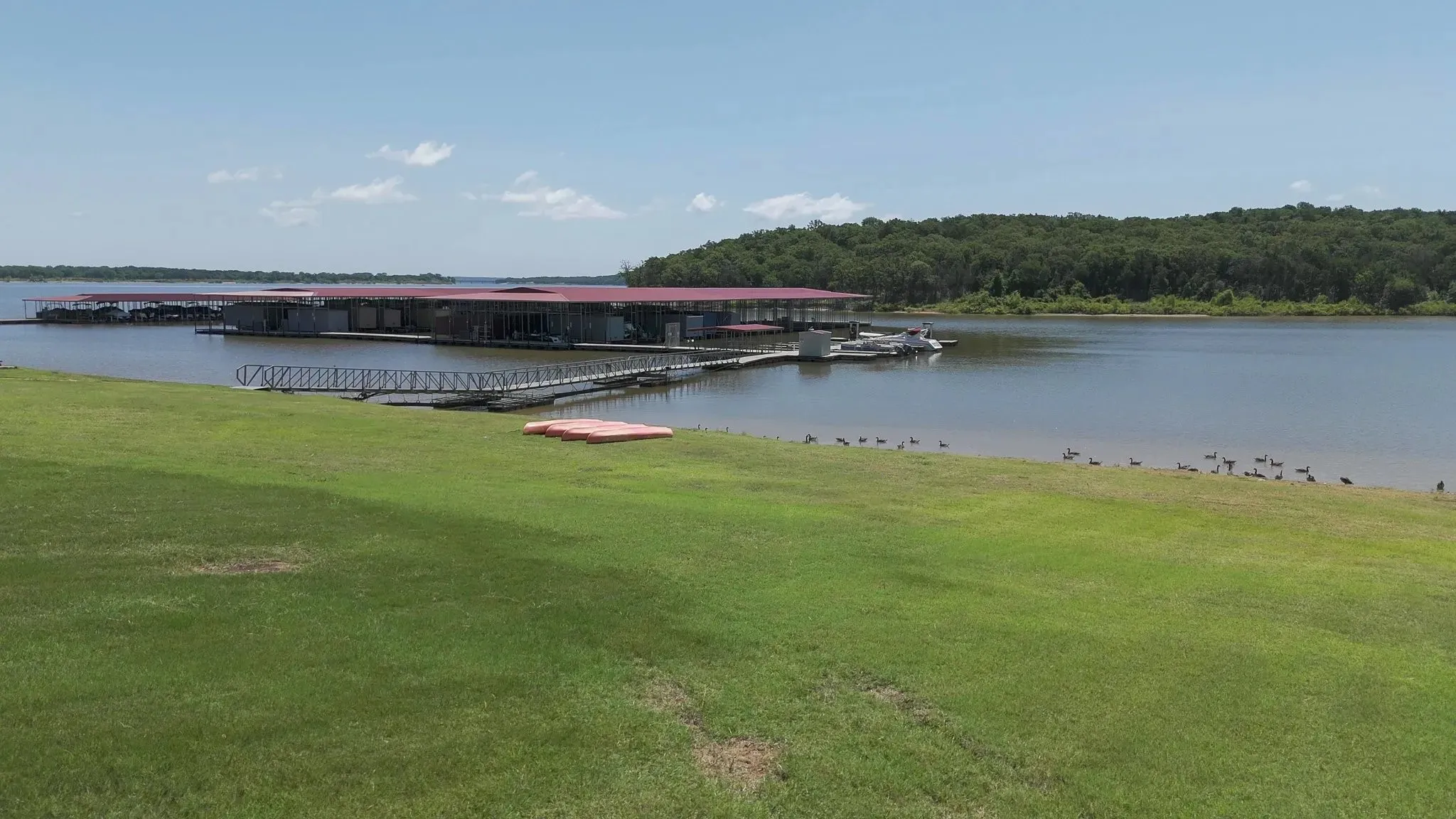 Dock with a water view and a lawn