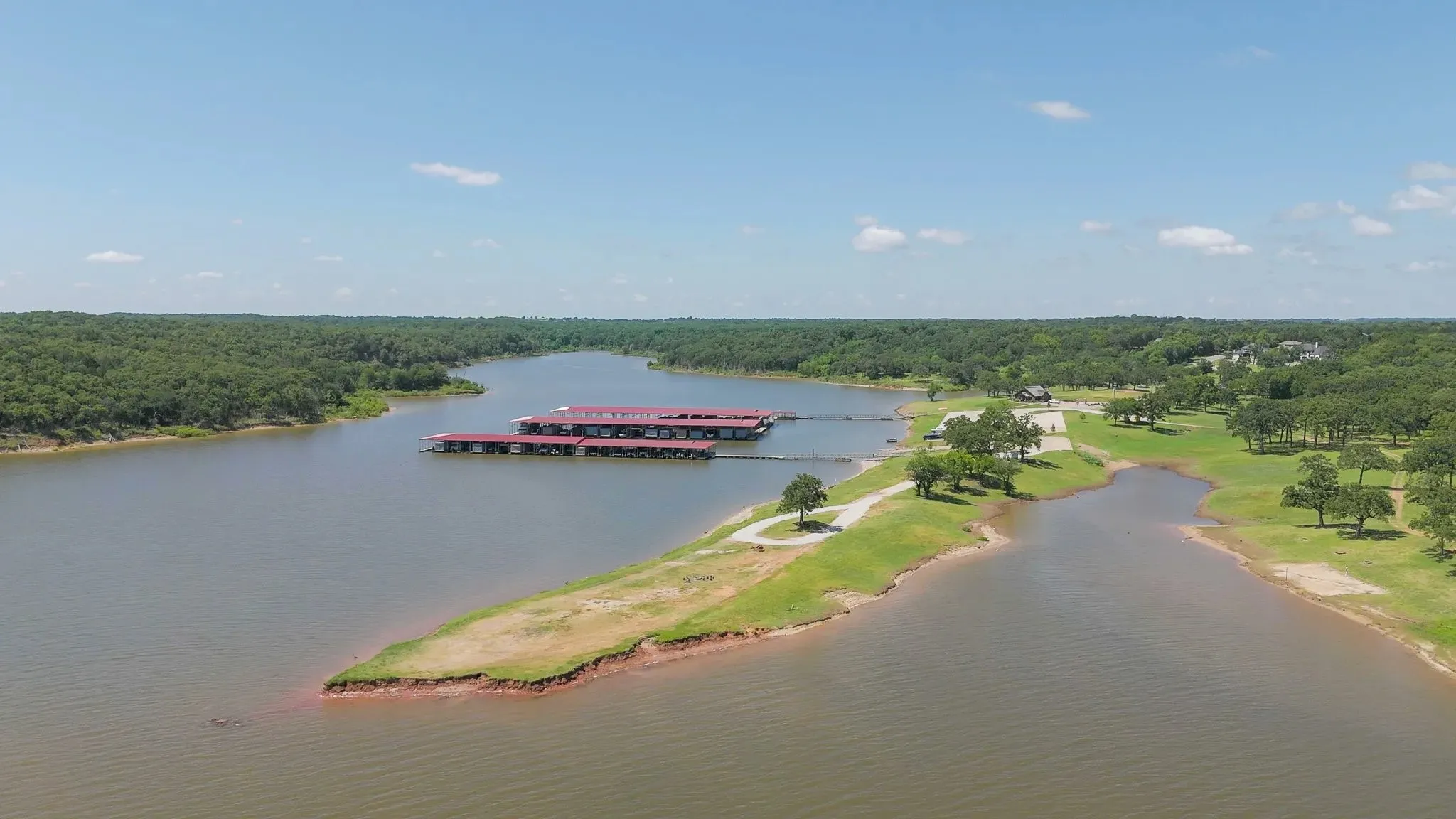 Aerial view of a heavily wooded area and a nearby body of water