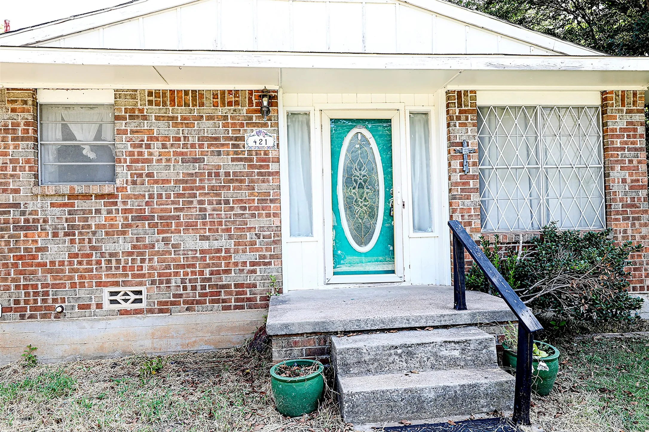 Doorway to property featuring brick siding
