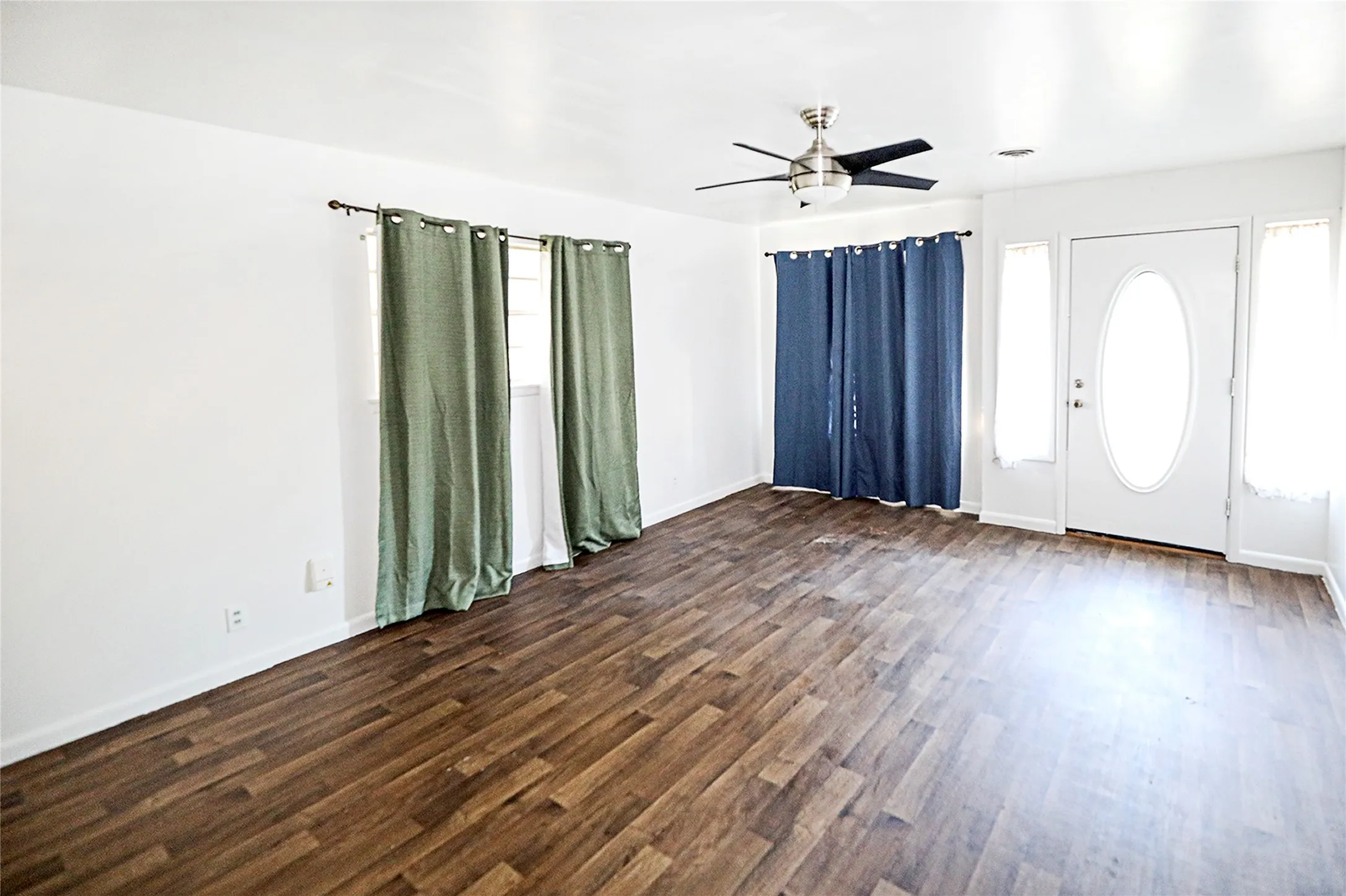 Entryway featuring a ceiling fan and dark wood finished floors