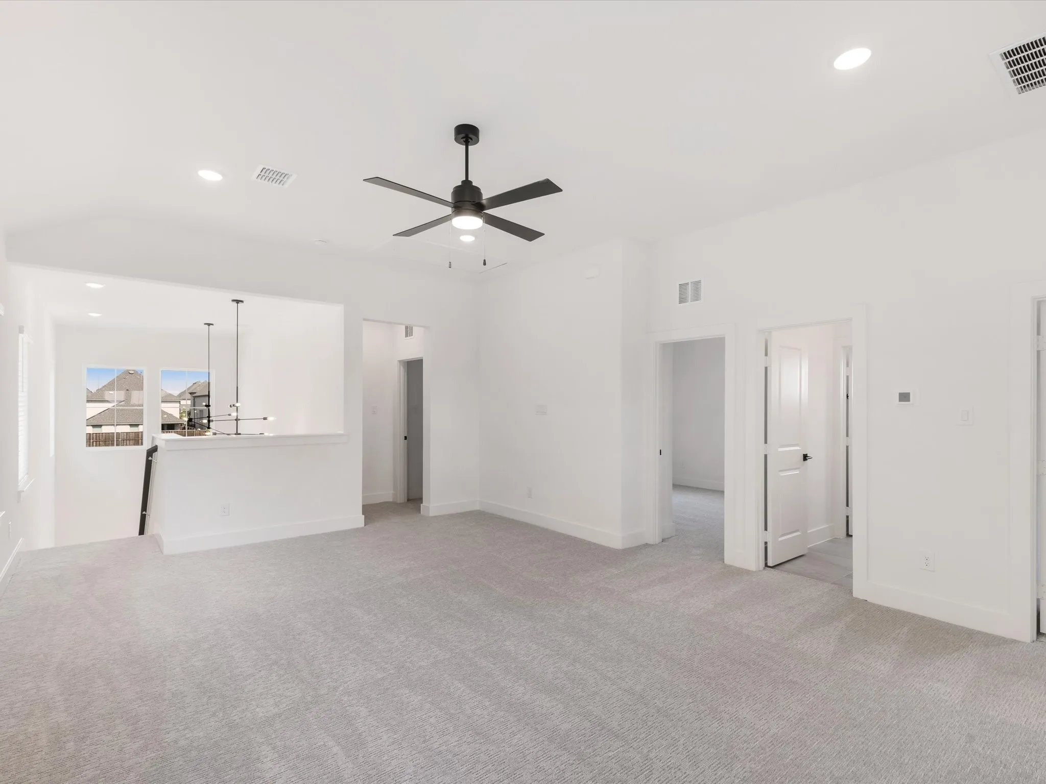 Unfurnished living room featuring light carpet, recessed lighting, and ceiling fan