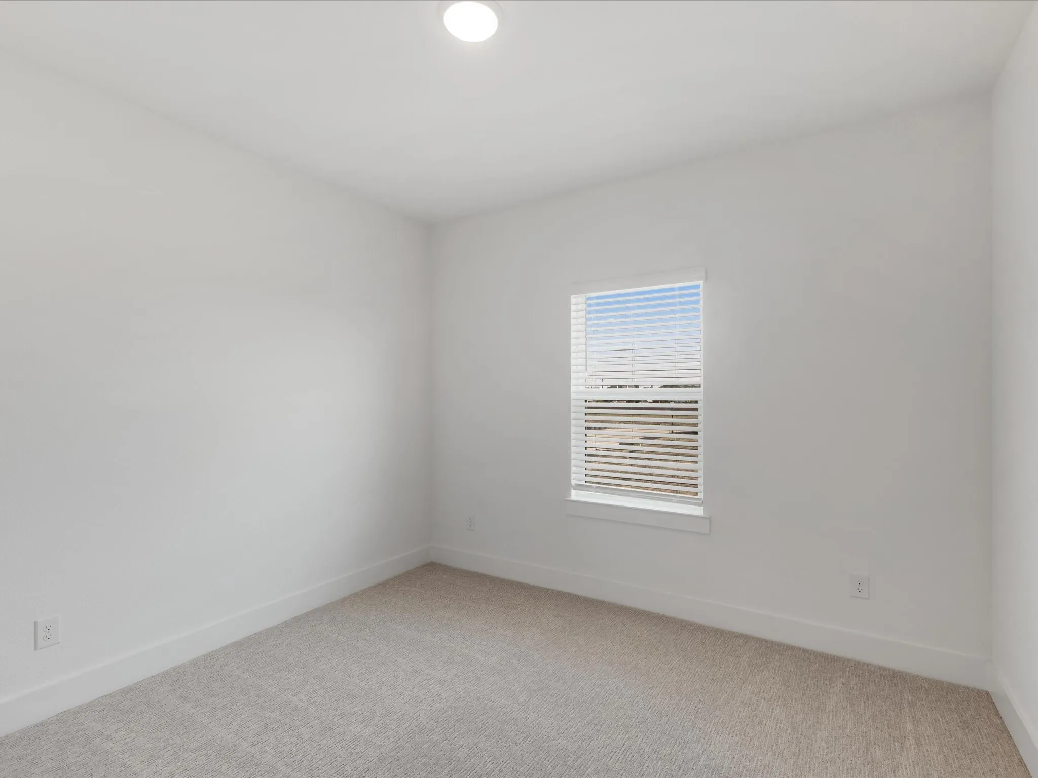Bedroom 3 with light colored carpet and recessed lighting