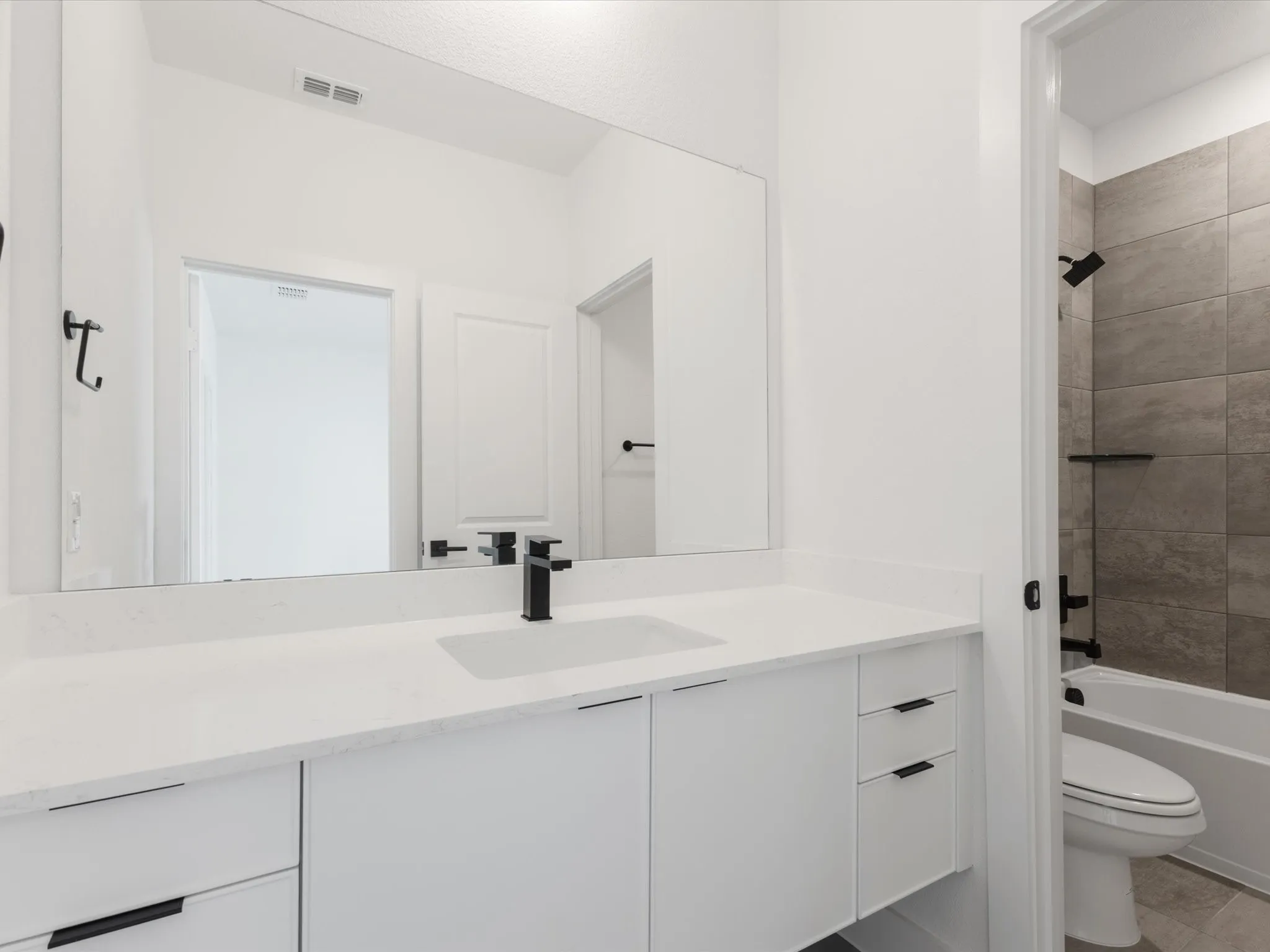Bathroom 2 with vanity, shower / bathtub combination, and tile patterned flooring