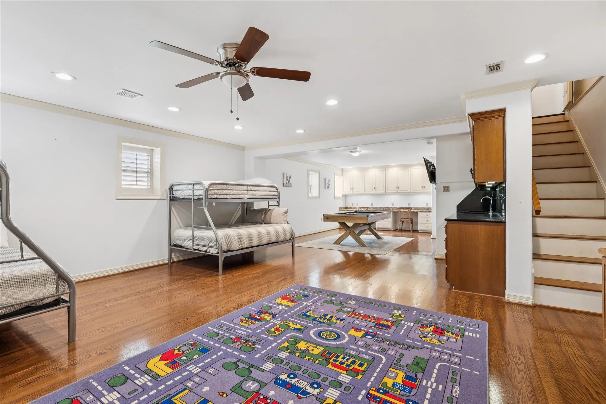 Bedroom featuring multiple windows, light wood-style floors, crown molding, recessed lighting, and a ceiling fan