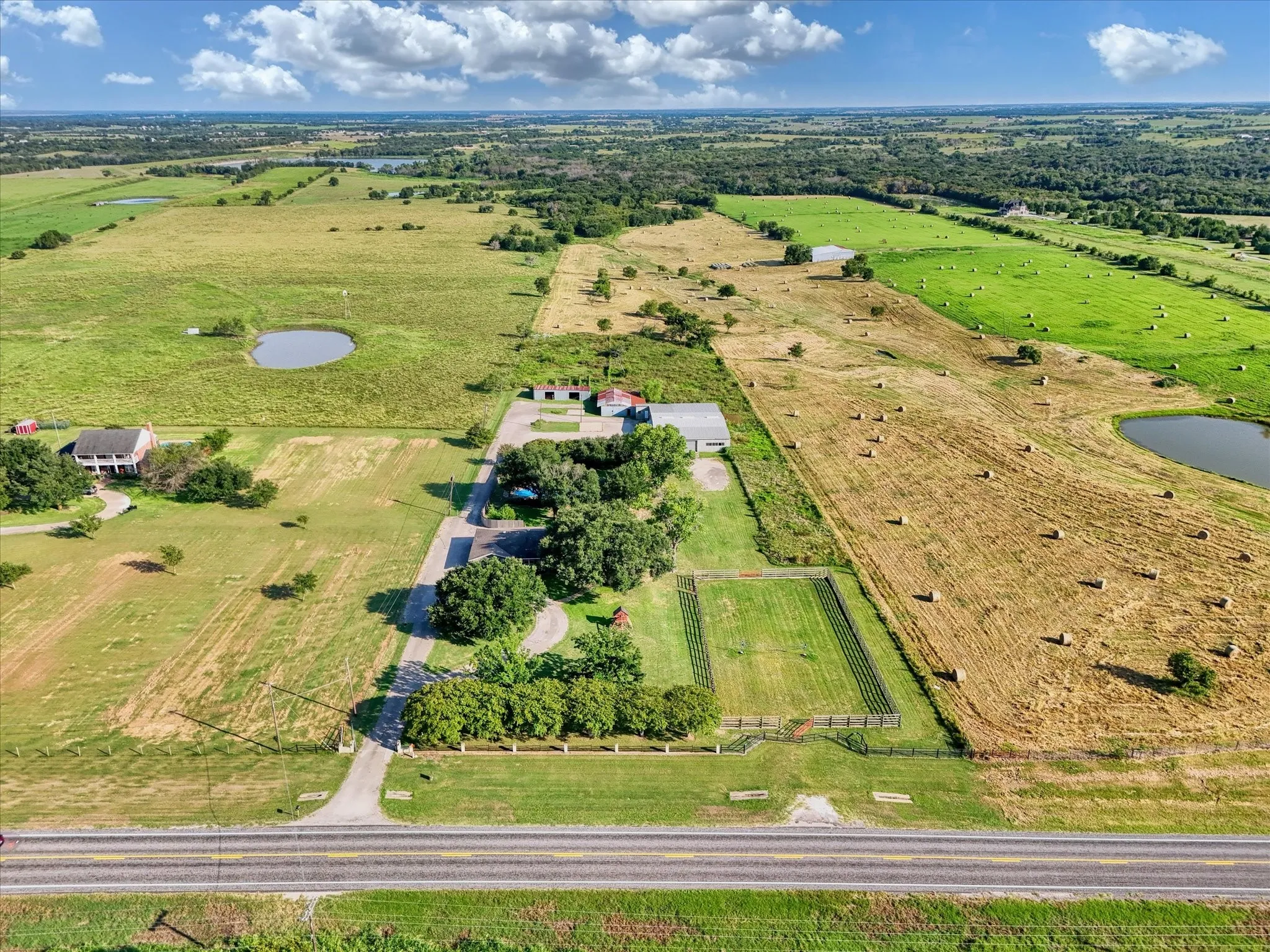 Aerial view of property's location with rural landscape, farmland, and a nearby body of water
