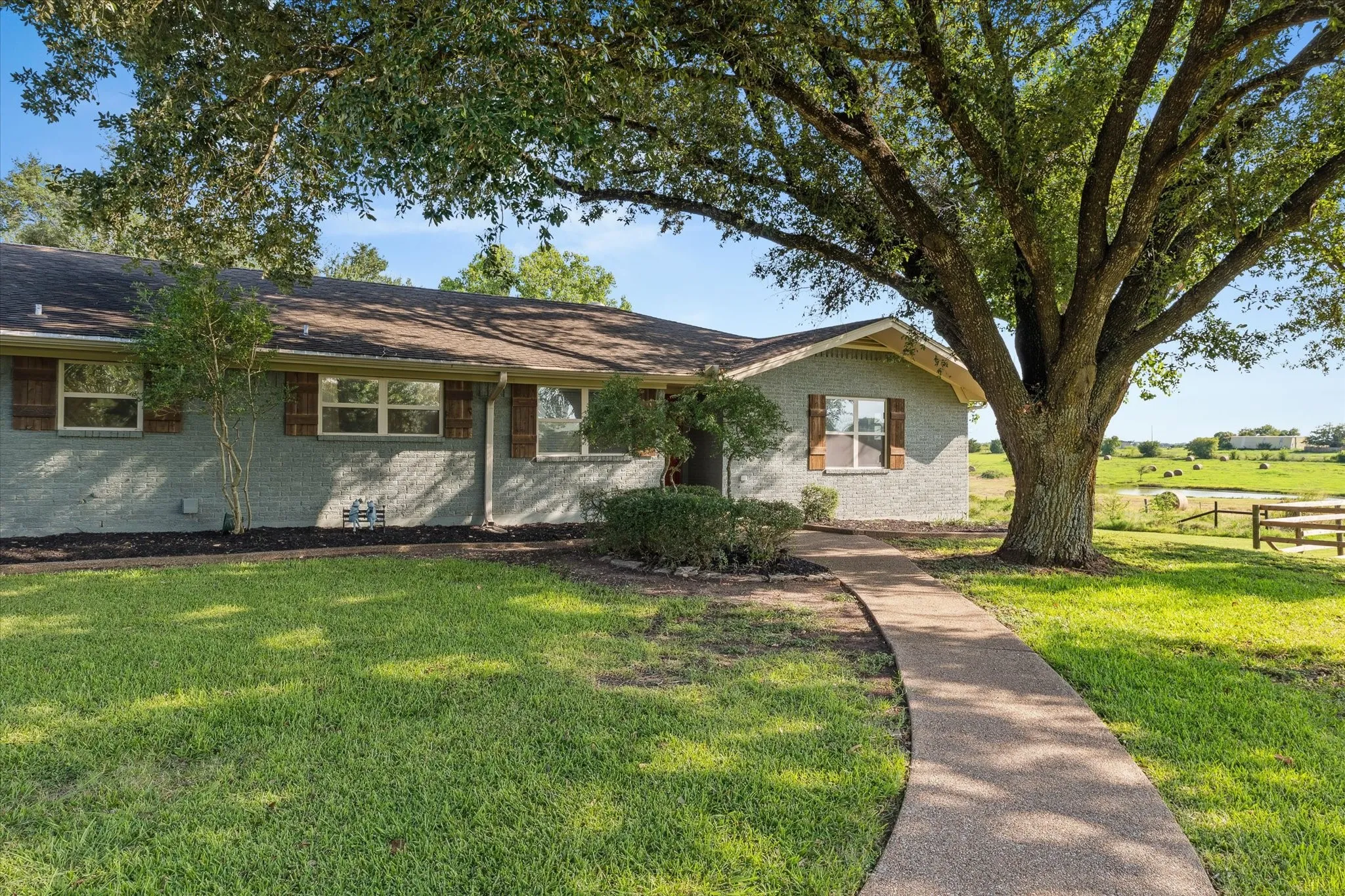 Ranch-style house featuring brick siding and a front lawn