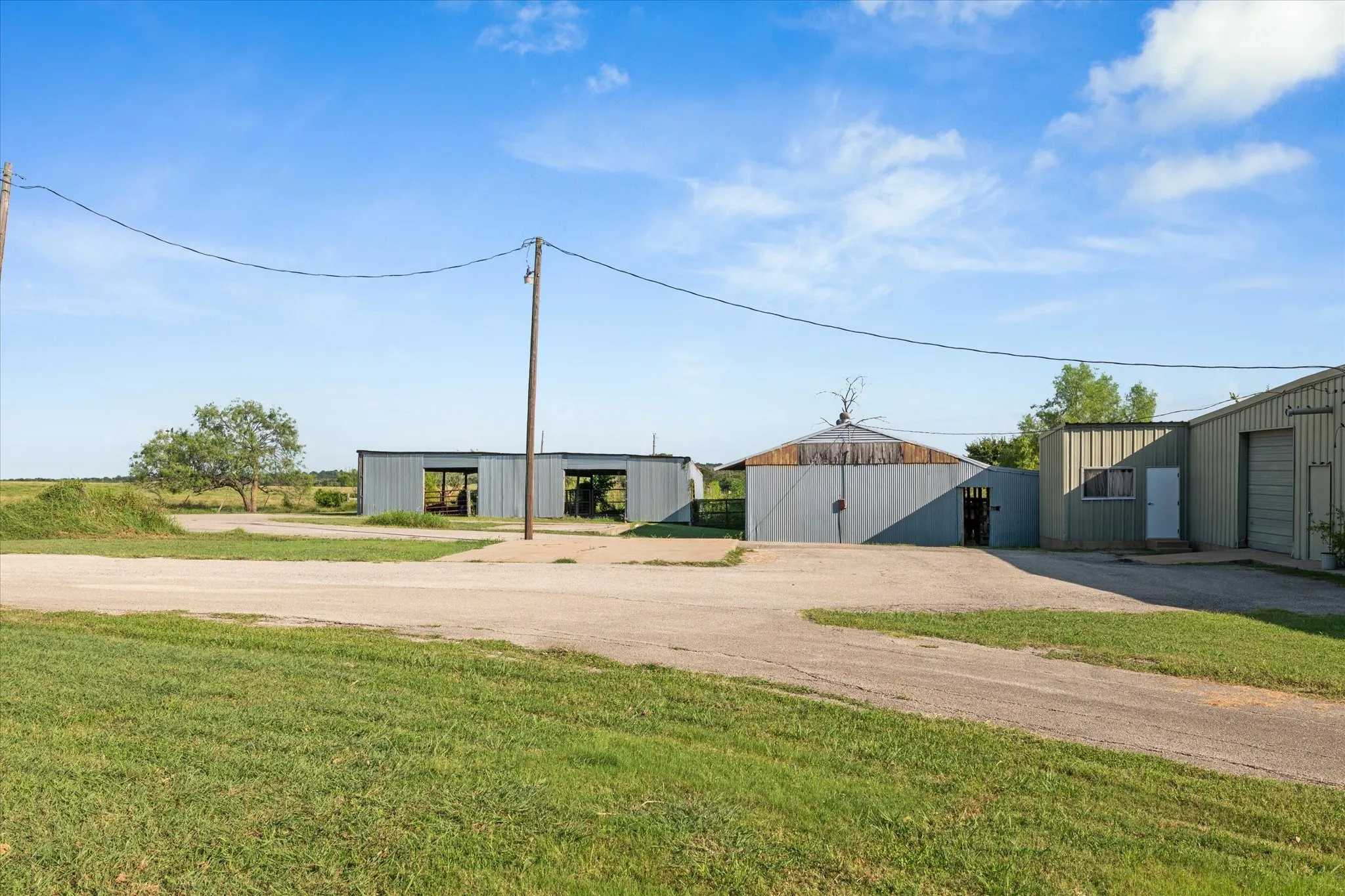 View of green lawn with an outbuilding and an outdoor structure