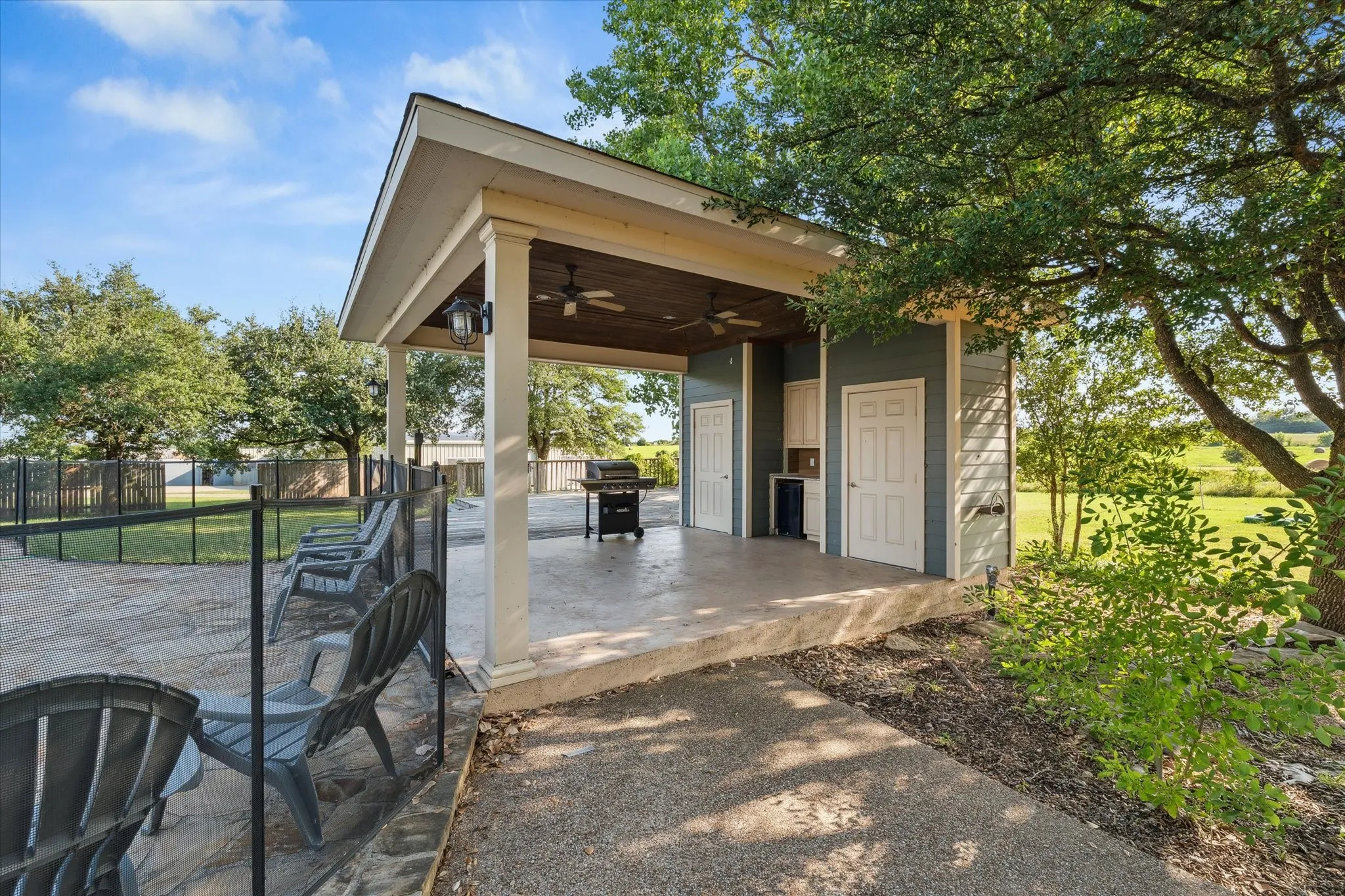 View of patio featuring a ceiling fan and a grill