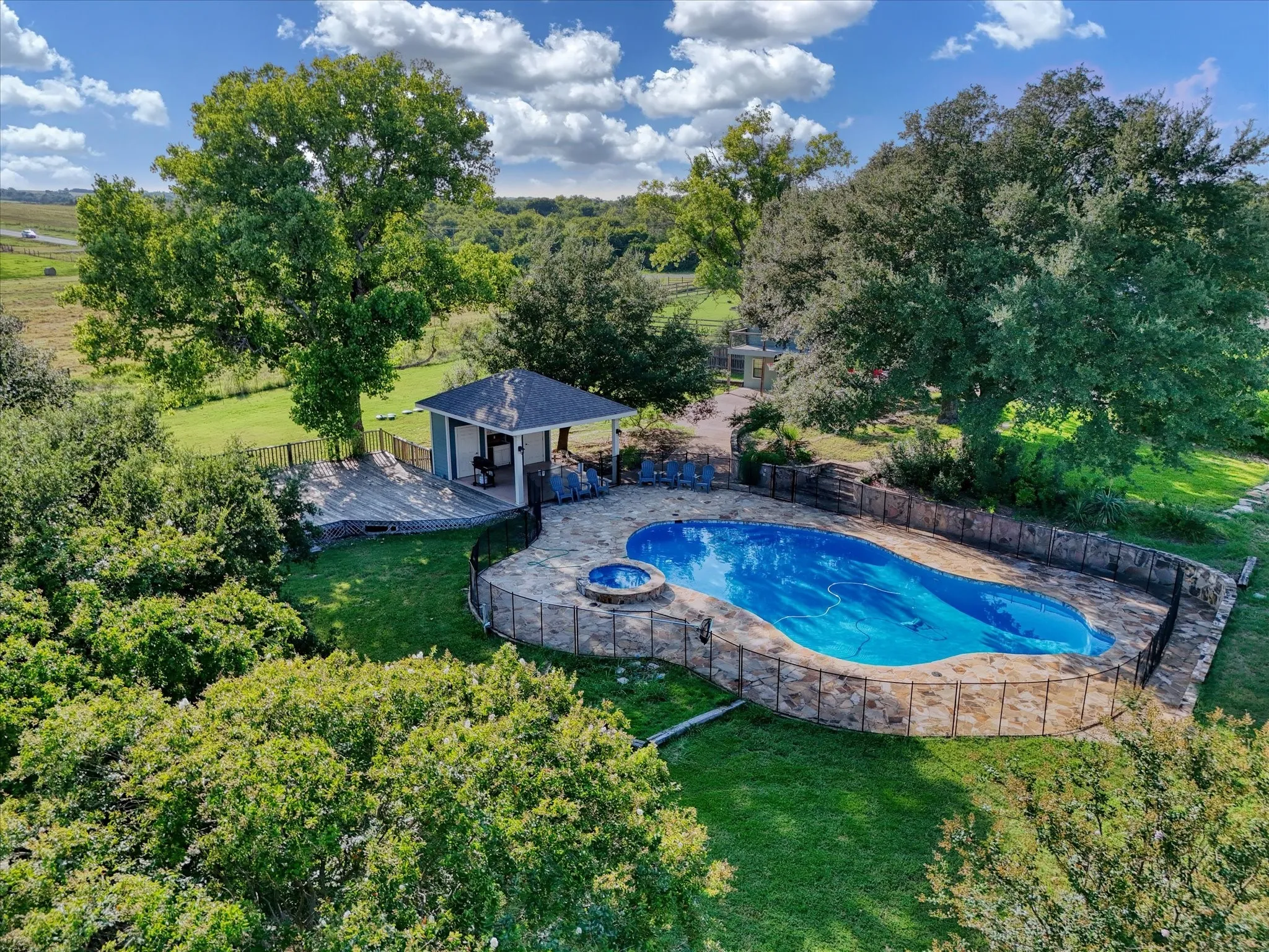 View of pool with a fenced backyard, a patio, and a pool with connected hot tub