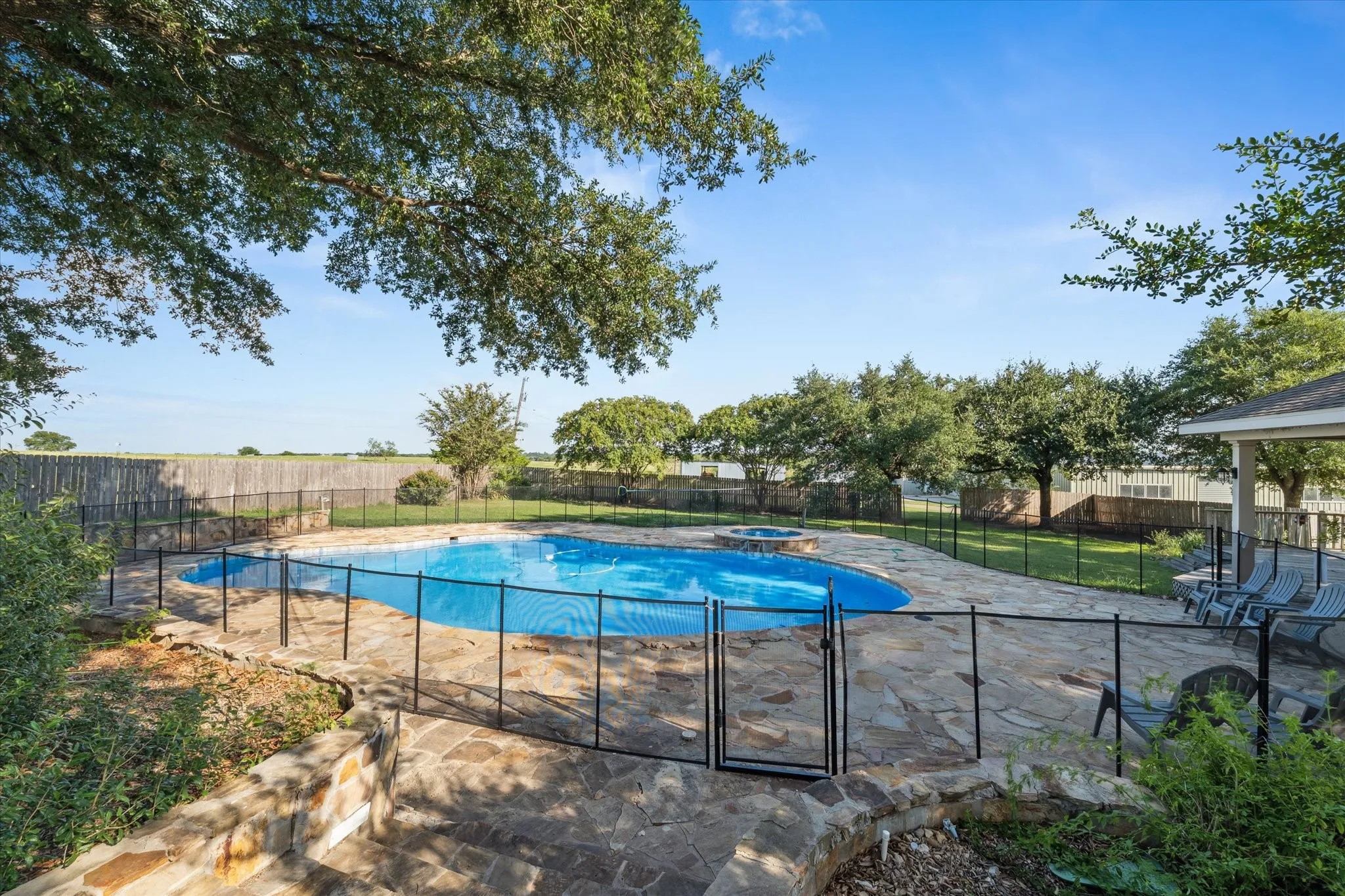 View of swimming pool with a patio area and a fenced backyard