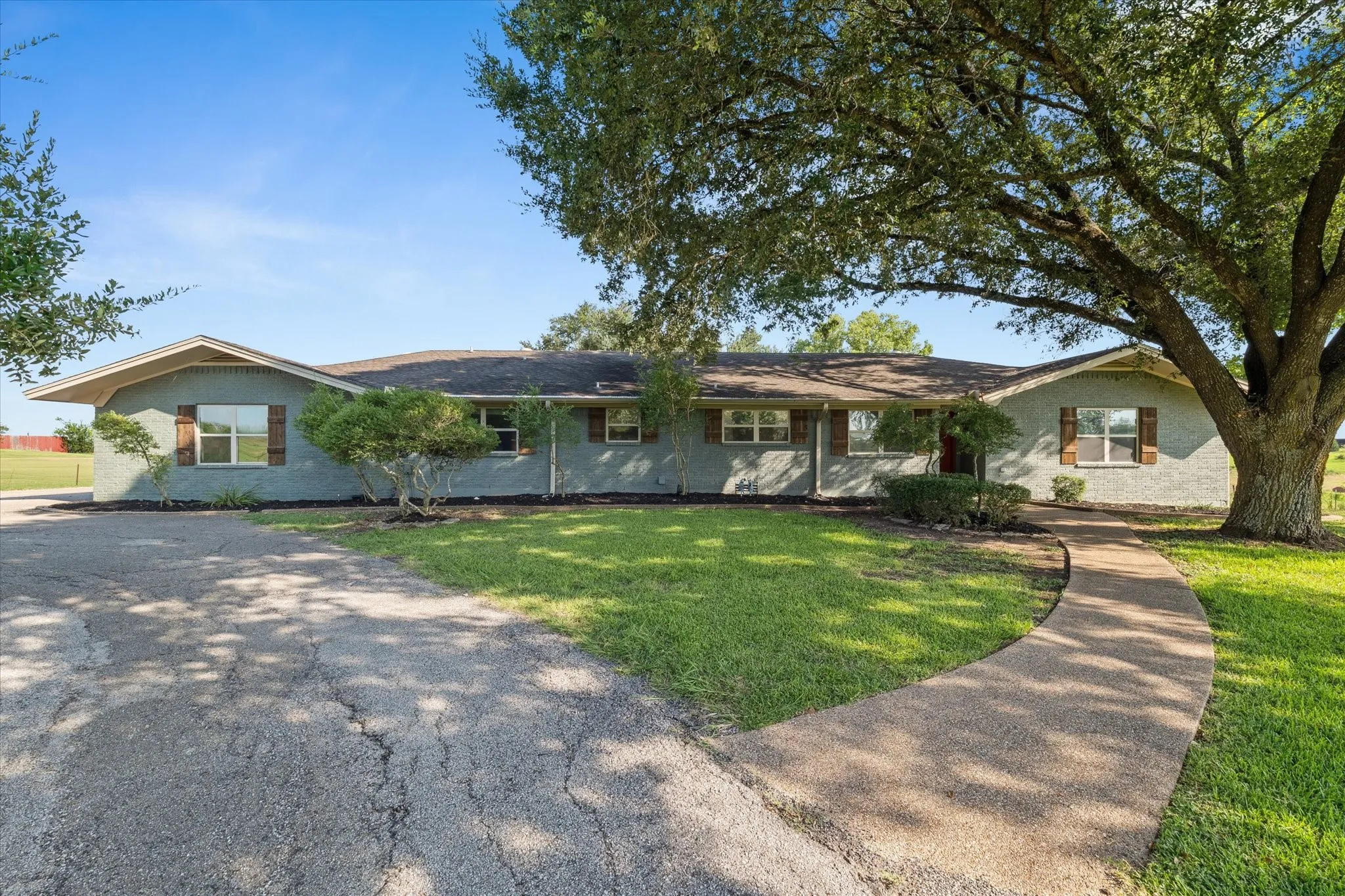 Single story home with a front yard and brick siding