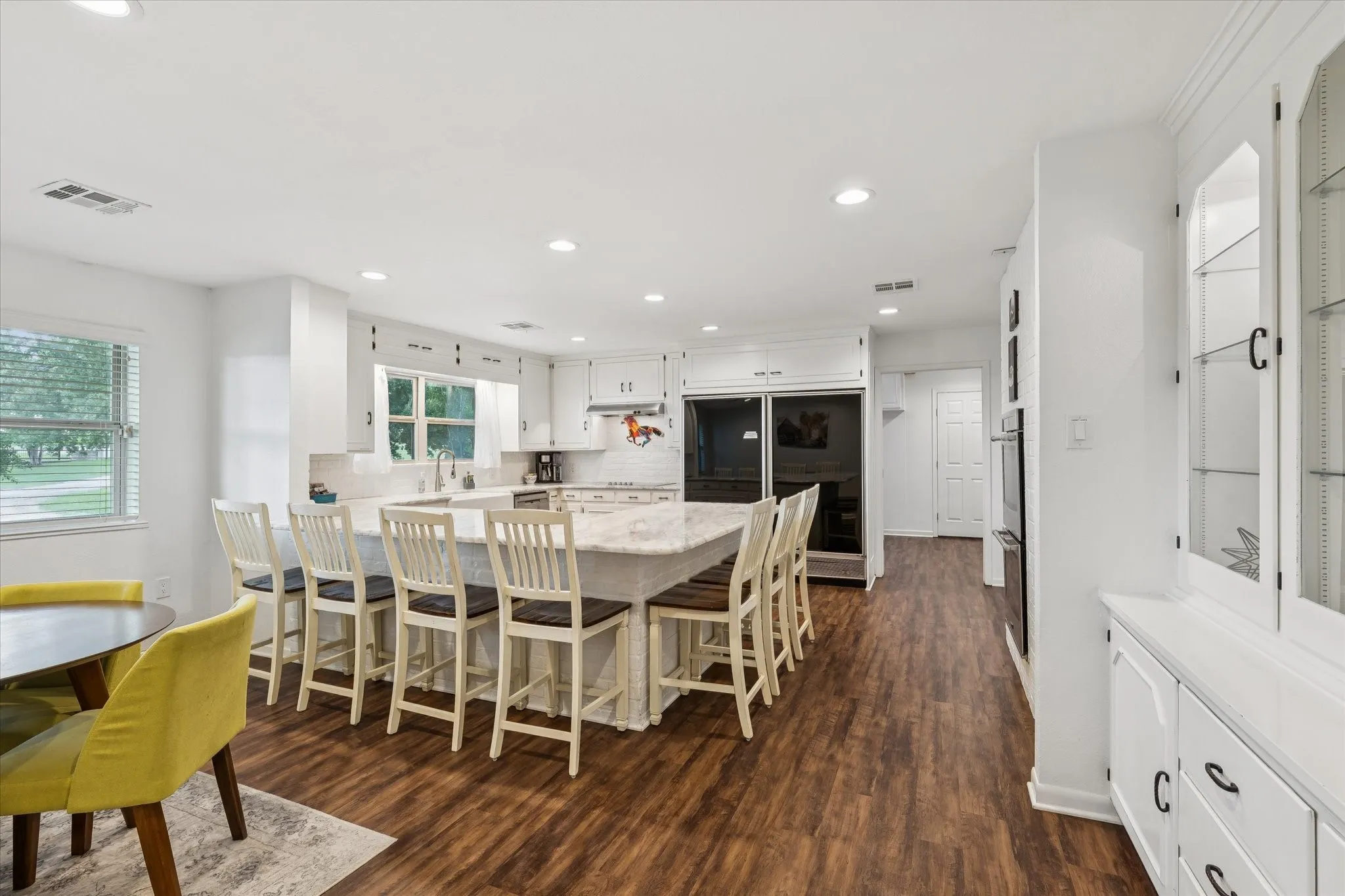 Dining space featuring recessed lighting and dark wood-style flooring