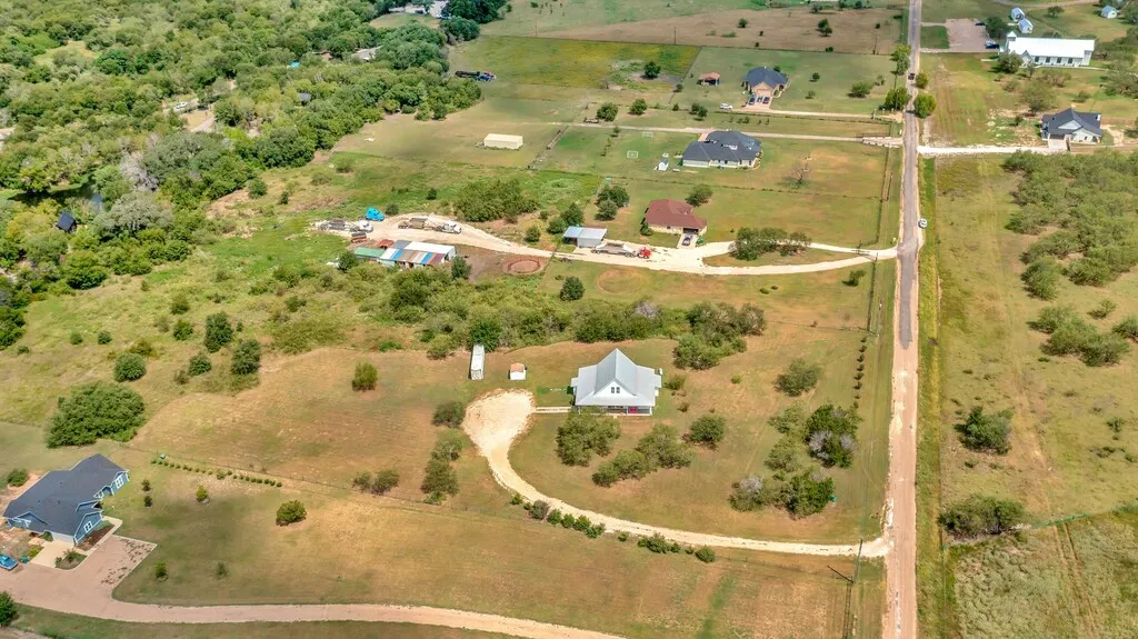 Aerial view of property and surrounding area featuring rural landscape
