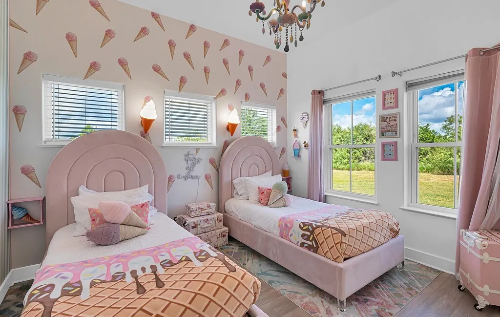 Bedroom featuring wood finished floors and a chandelier
