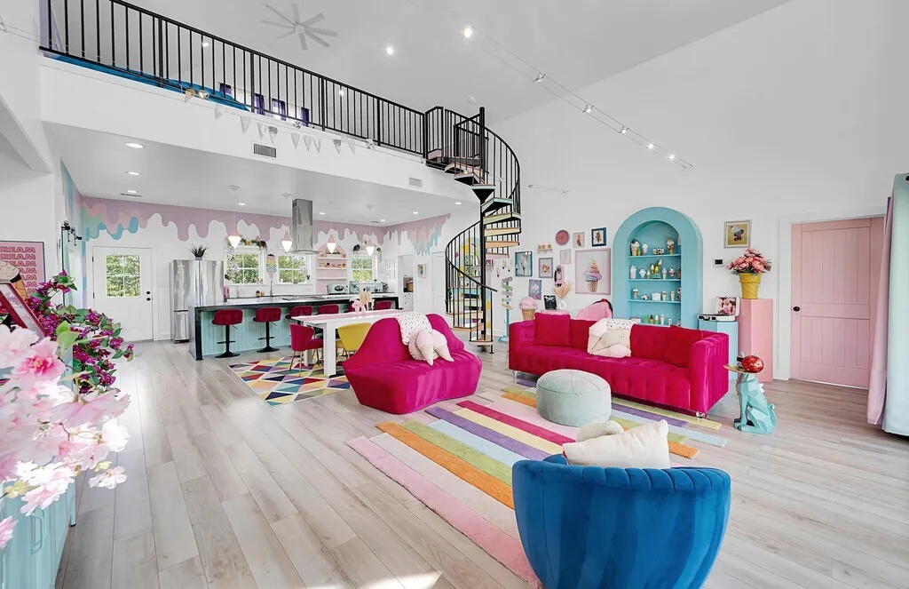 Living room with a towering ceiling, light wood finished floors, stairs, and recessed lighting