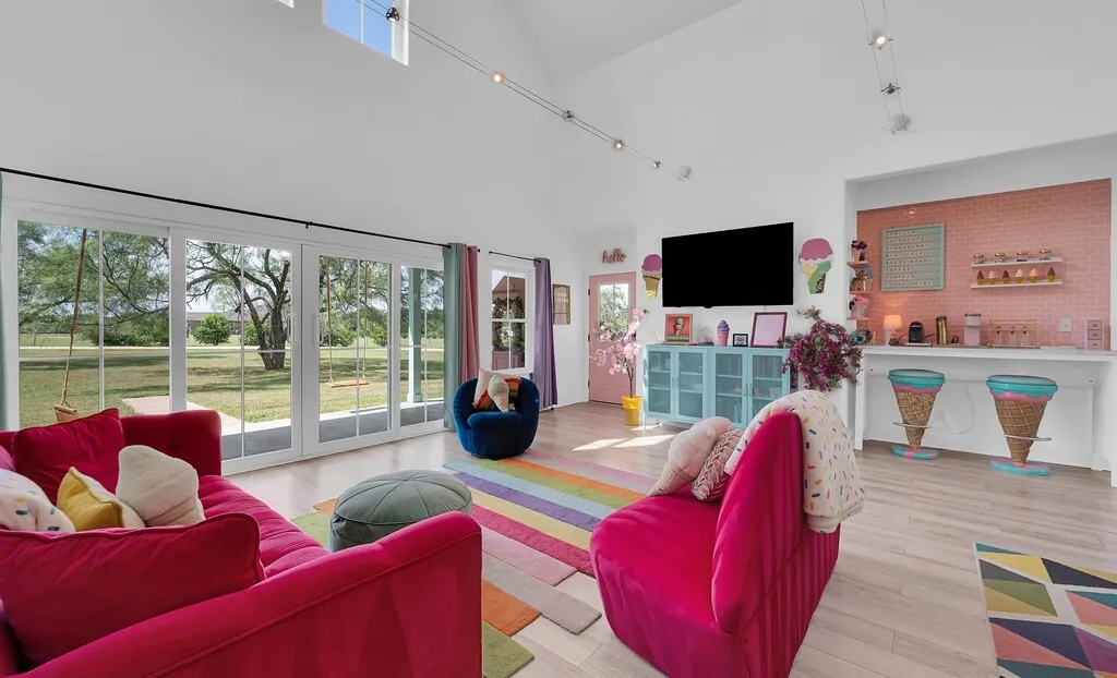 Living room with a high ceiling and light wood-style floors