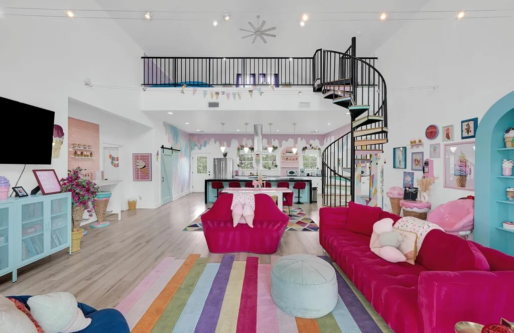 Living room featuring wood finished floors, high vaulted ceiling, stairway, and recessed lighting