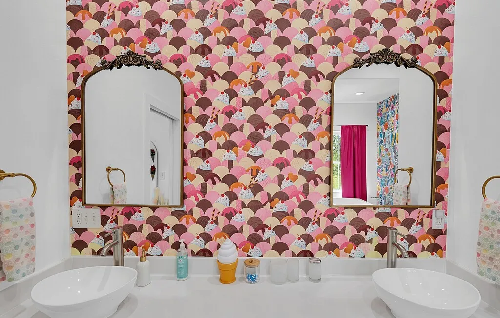 Half bathroom featuring a sink and wallpapered walls