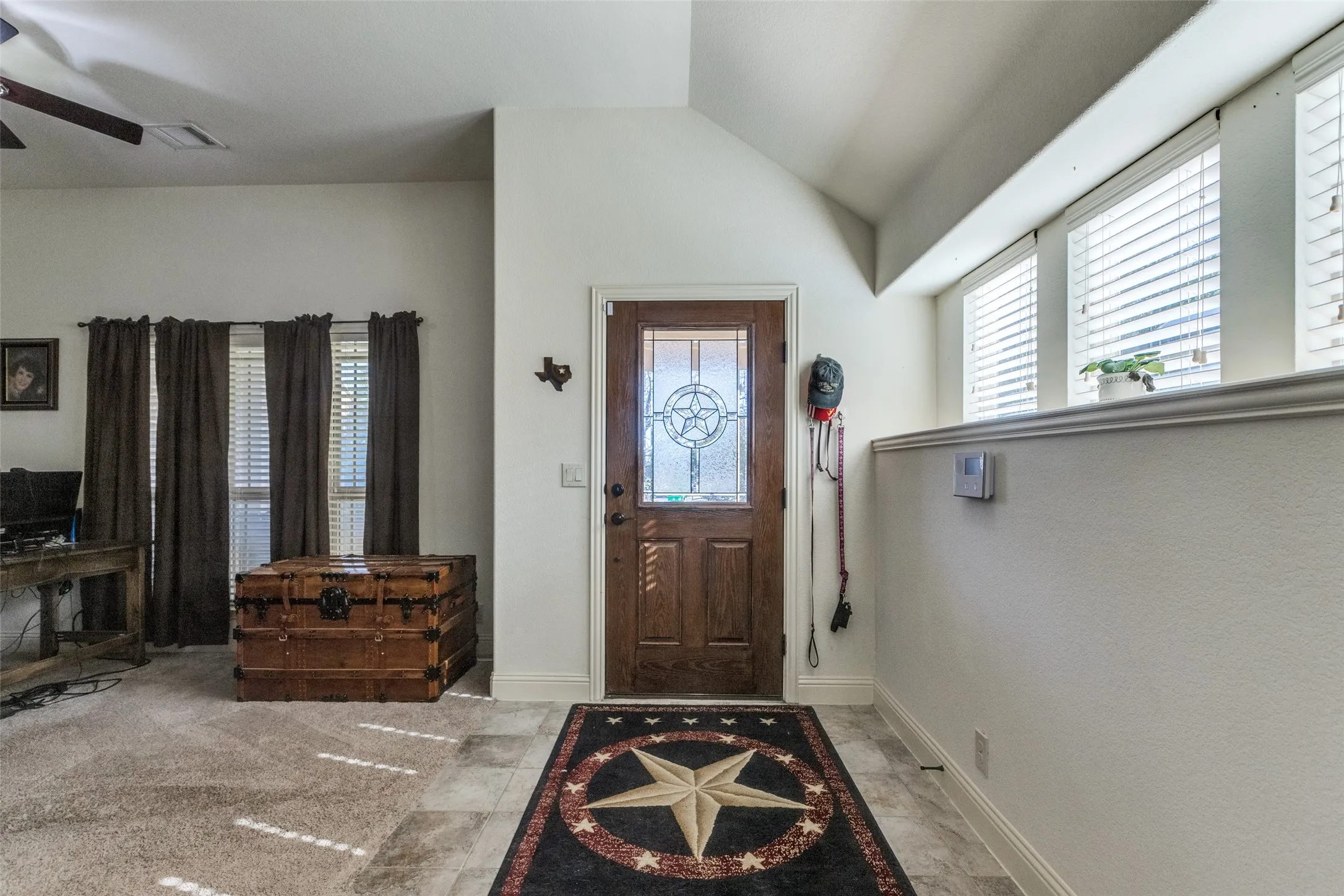 Foyer featuring vaulted ceiling and ceiling fan