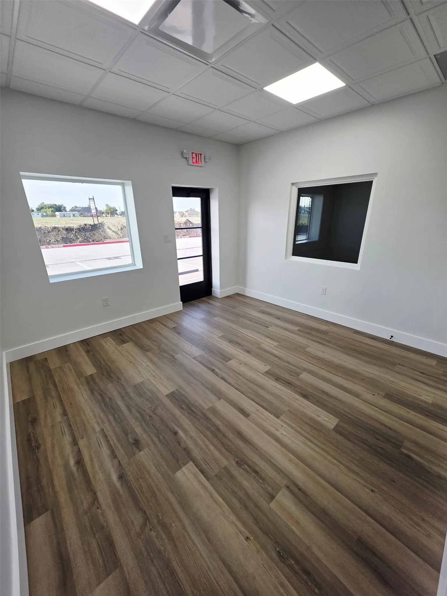 Unfurnished room featuring baseboards and wood finished floors