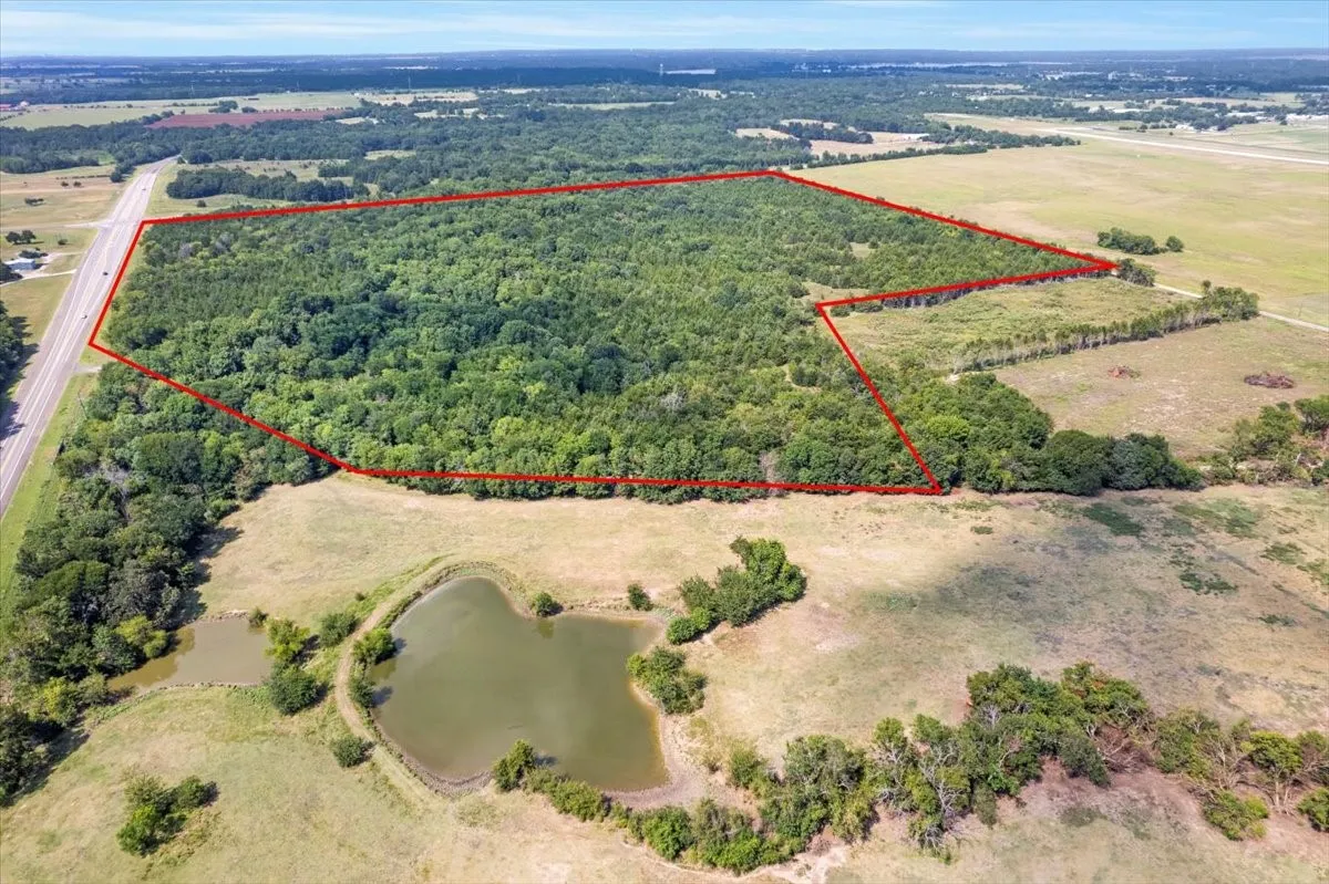 Aerial overview of property's location with property boundaries highlighted and a large body of water