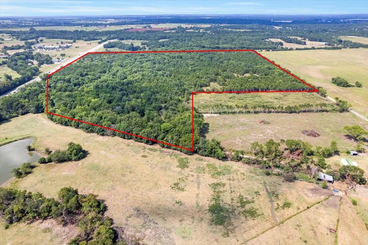 Overview of rural landscape with a large body of water and property parcel outlined