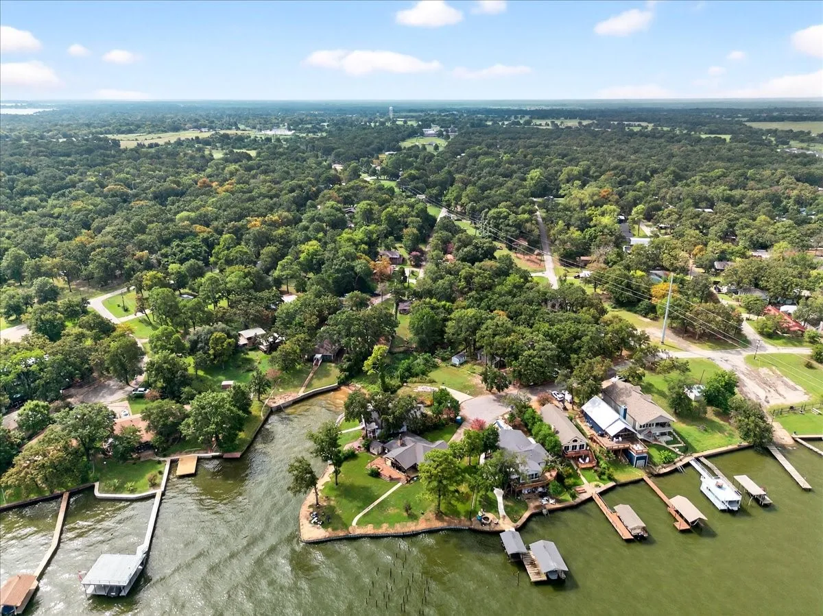 Aerial view of property's location with a large body of water