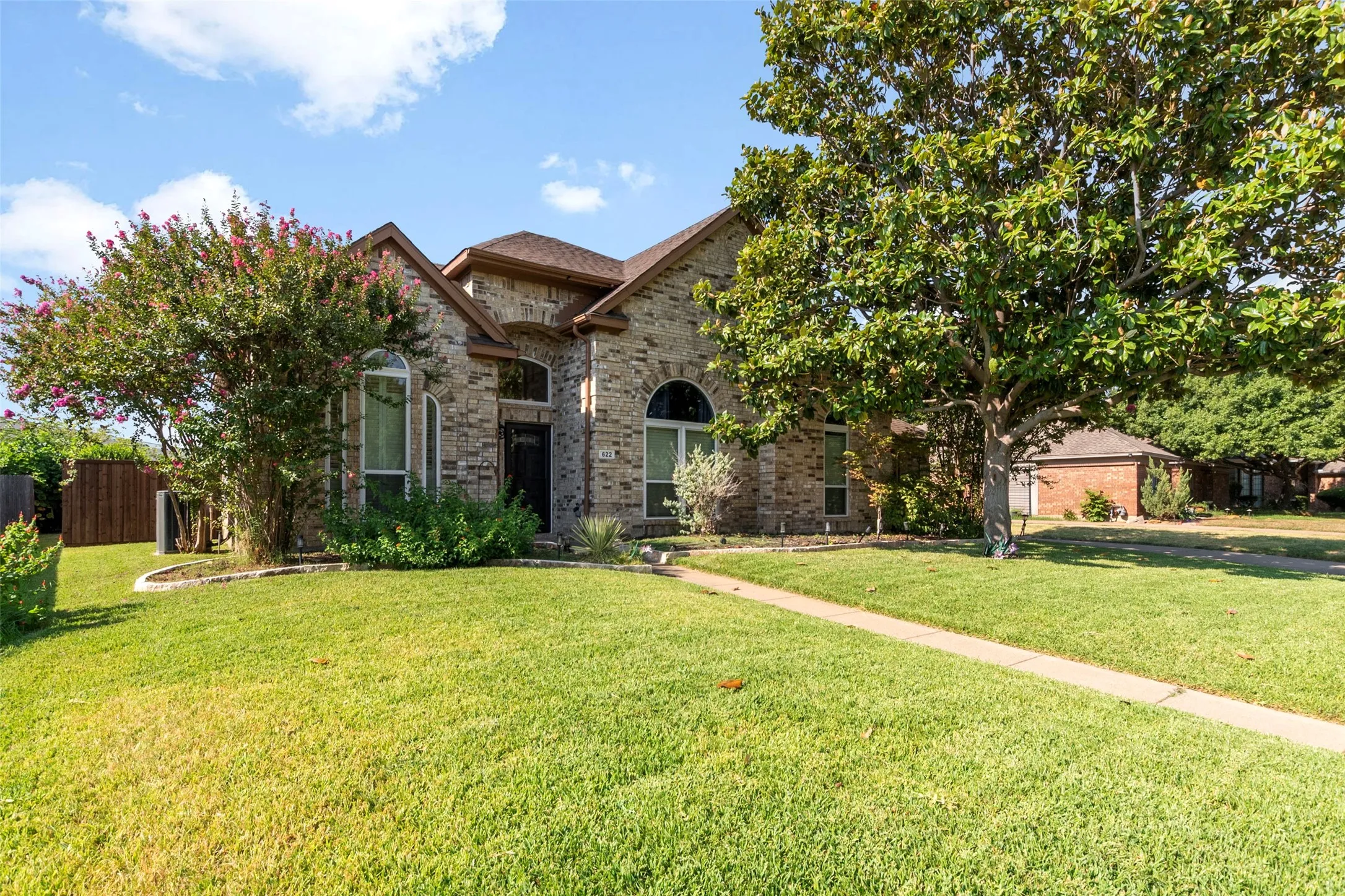 Brick exterior with a gabled roof and arched windows