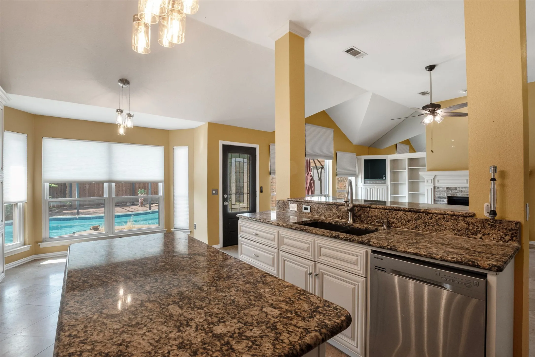 Kitchen featuring granite countertops, stainless steel dishwasher, and built-in sink