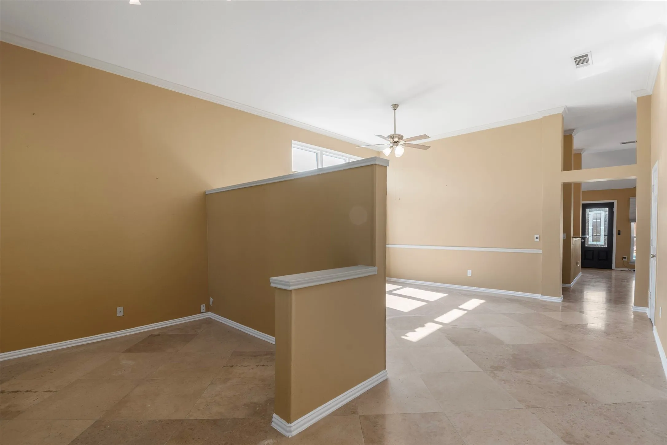 Vaulted ceilings with crown molding and ceiling fan