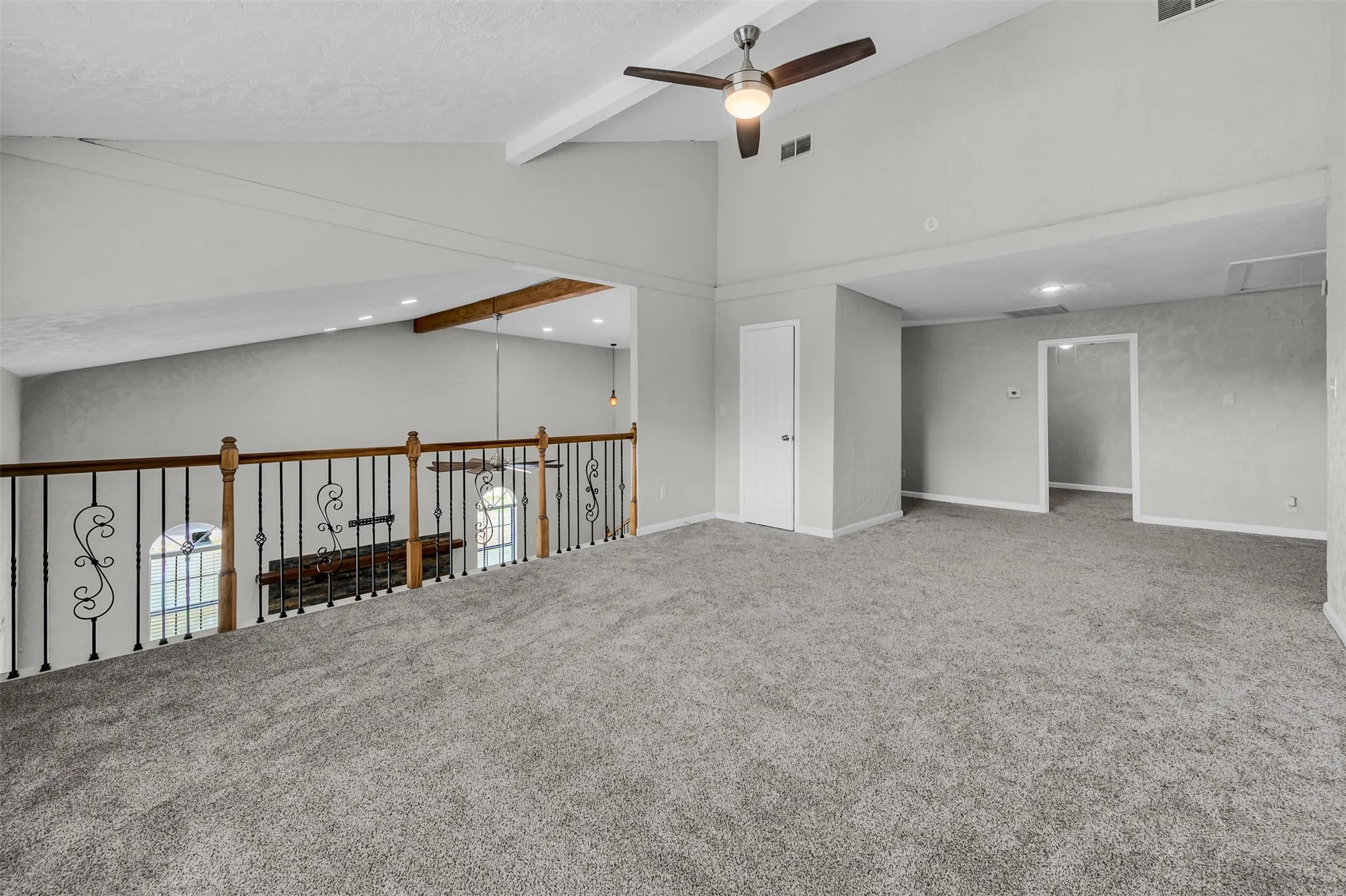 Carpeted spare room with beam ceiling, ceiling fan, recessed lighting, and high vaulted ceiling