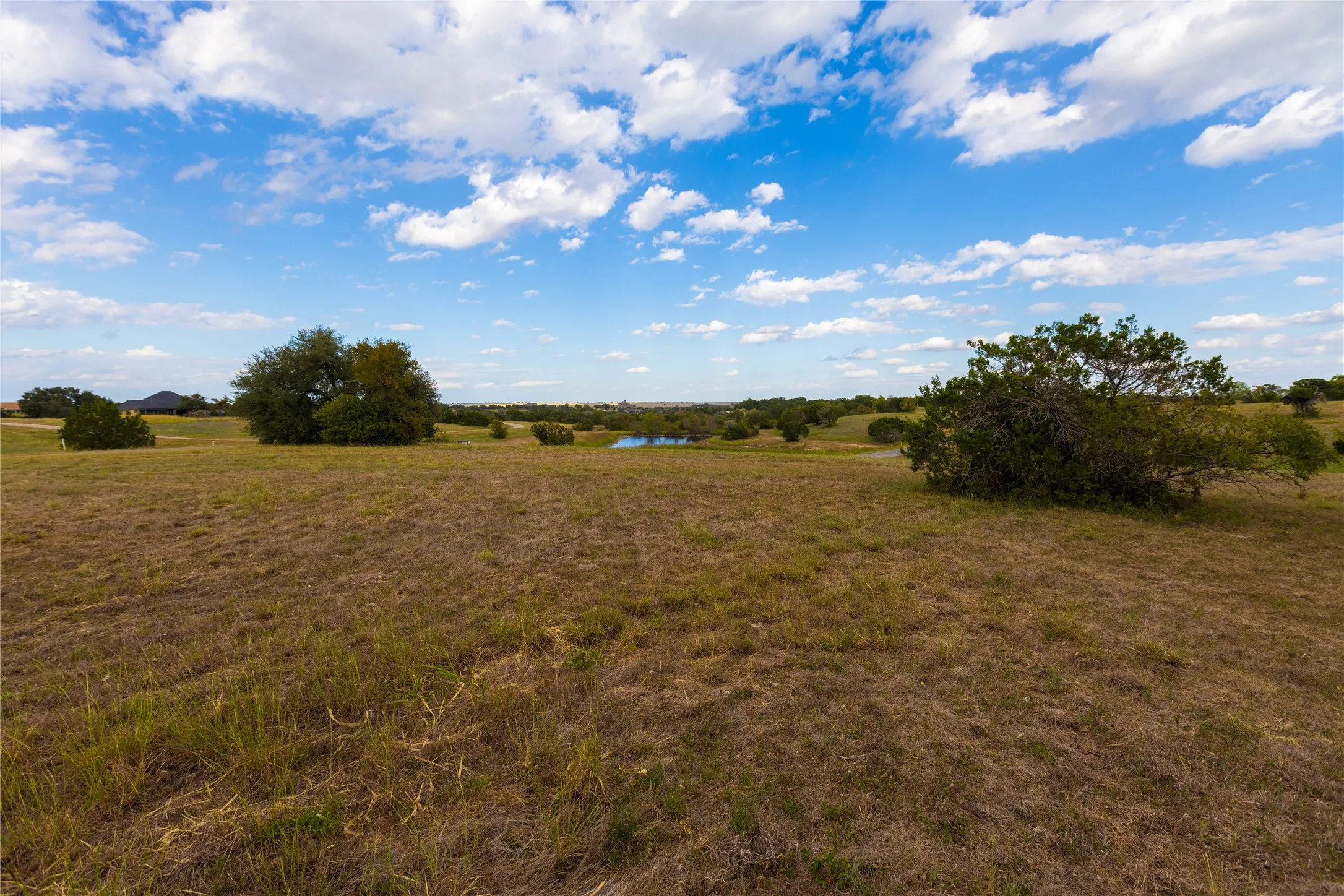 View of grassy yard with a view of rural / pastoral area and a water view