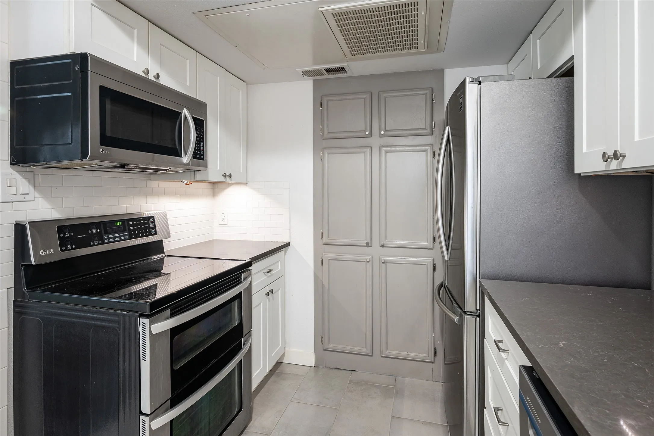 Kitchen features storage wall for pantry and small appliances