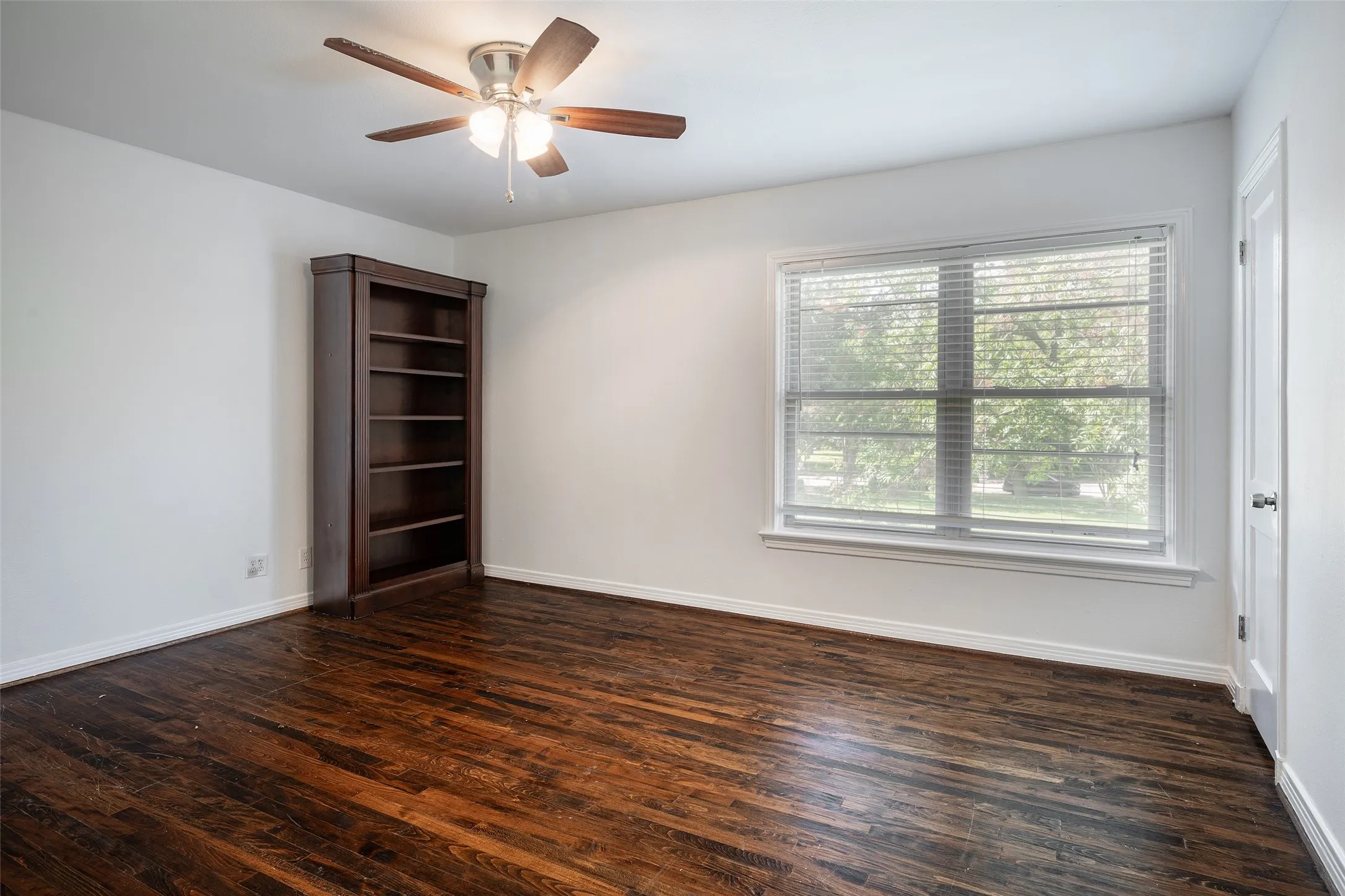 Primary Bedroom with free standing shelves and walk in closet