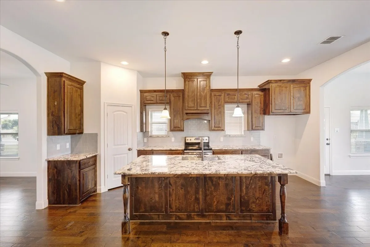 Chefs kitchen with beautiful granite counters, huge island with electric, all open to living area with wood burning FP and breakfast area