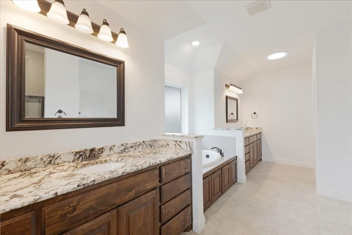 Huge Master bathroom with lovely granite counters, garden tub, his and her sinks, separate shower, private toilet area