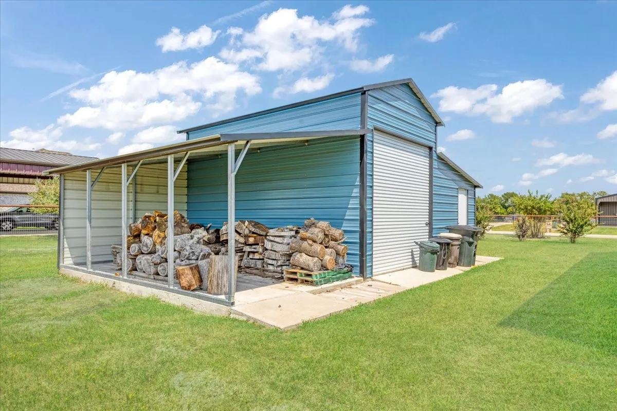 23X20 workshop with 10' roll up door and 20X11 rear overhang with concrete for parking or storage