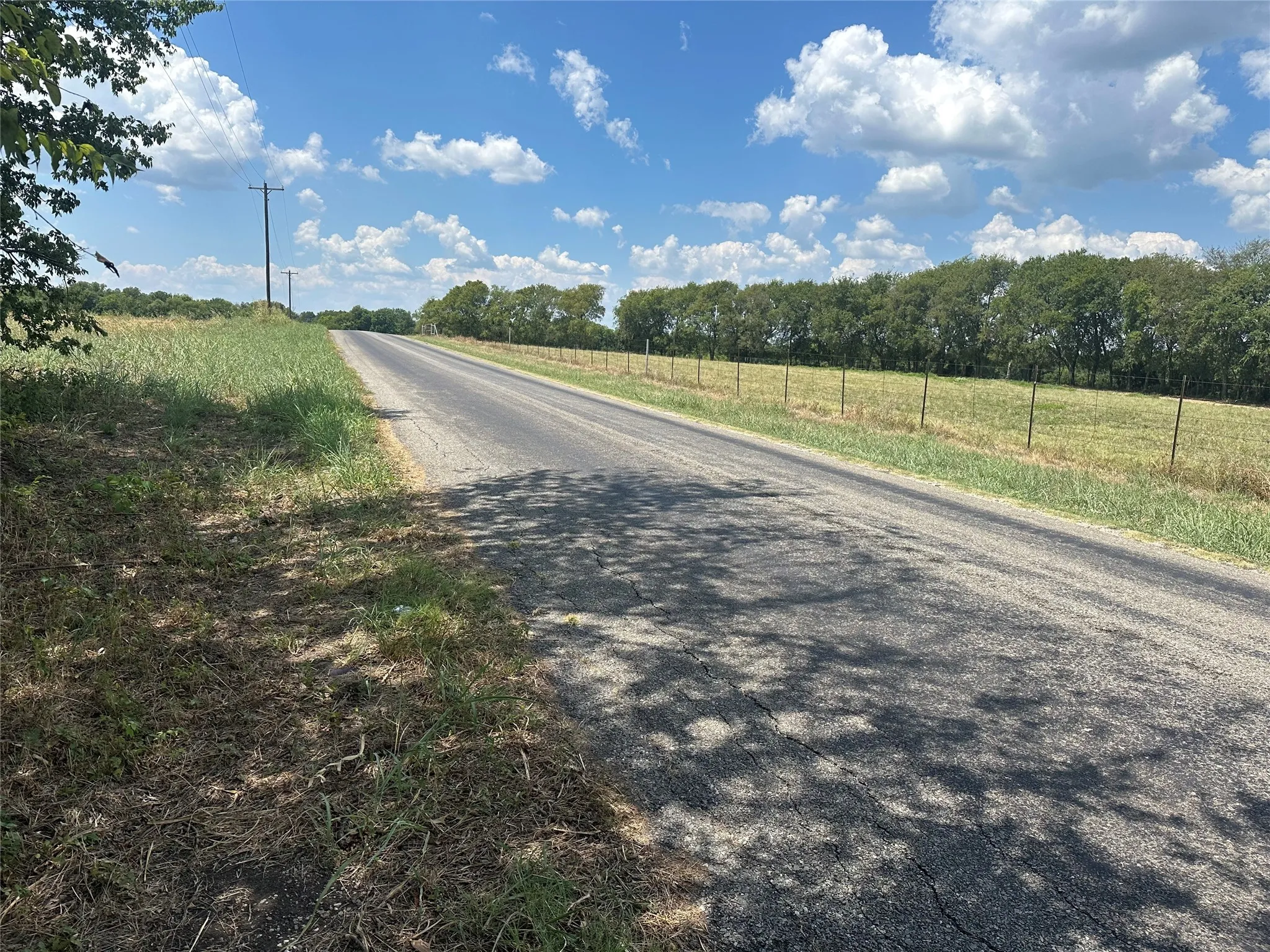 View of asphalt road with a view of countryside