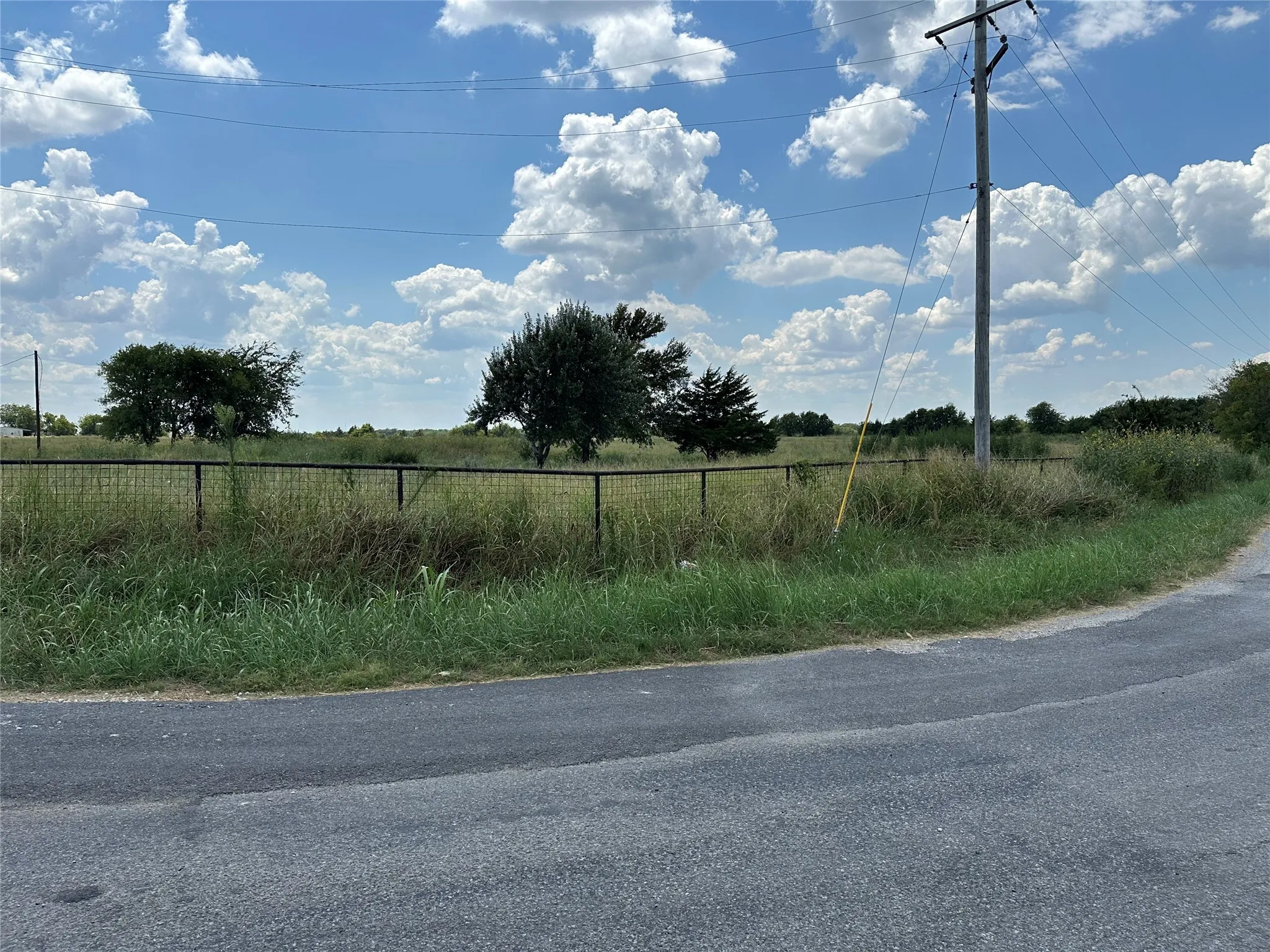 View of asphalt road featuring a view of countryside