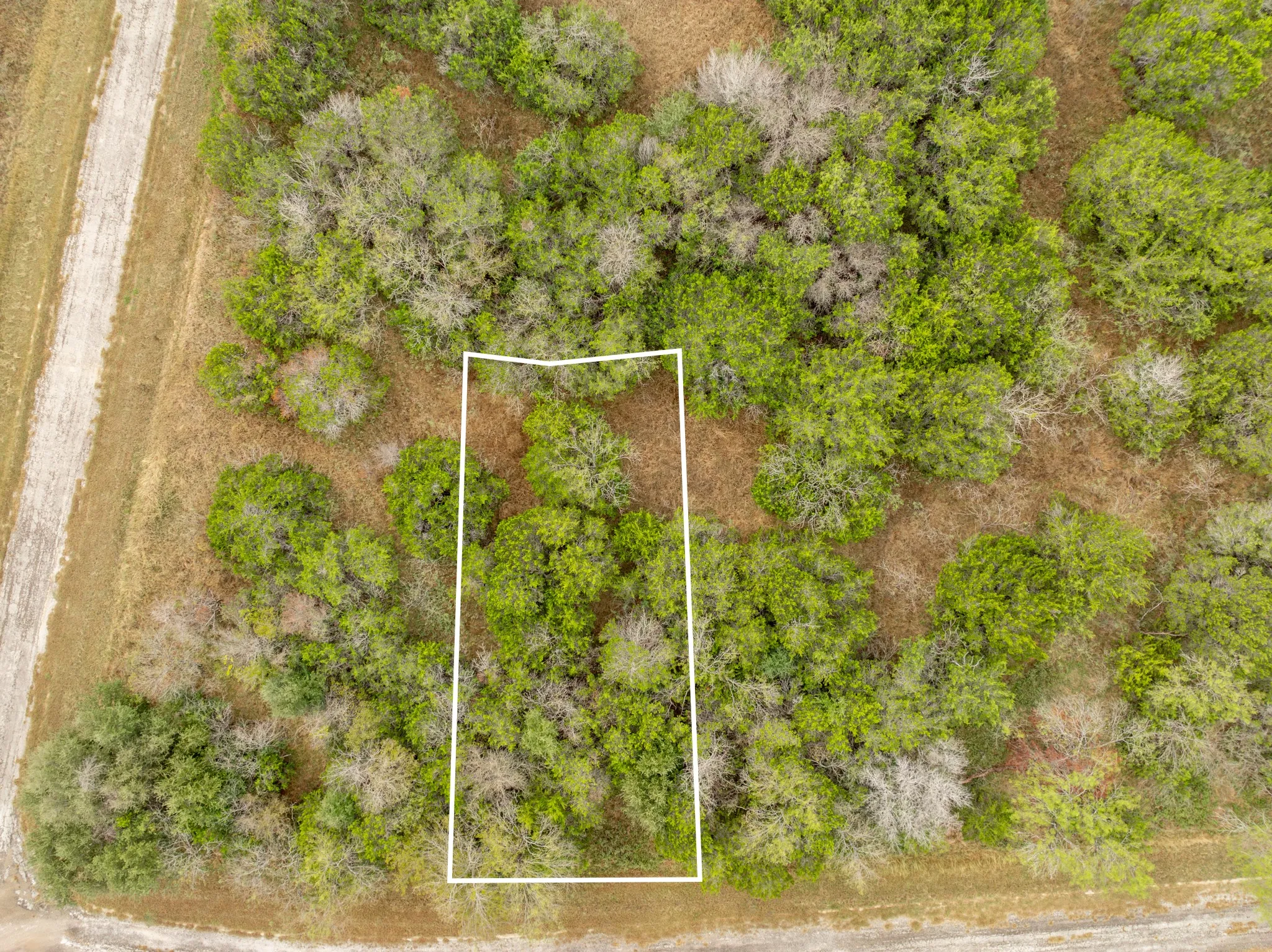 Aerial view of property and surrounding area with property parcel outlined