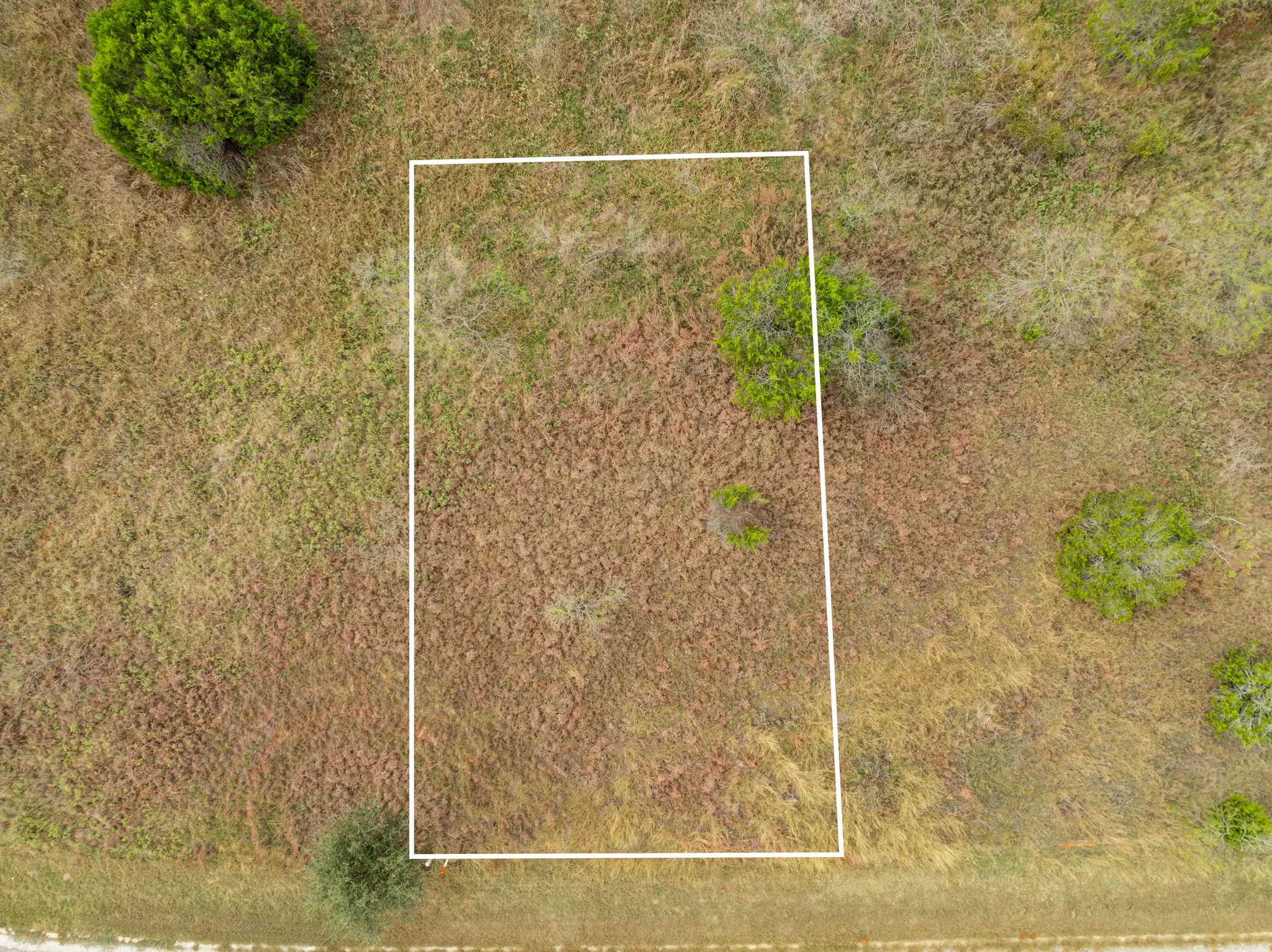 Aerial view of property and surrounding area featuring property boundaries highlighted