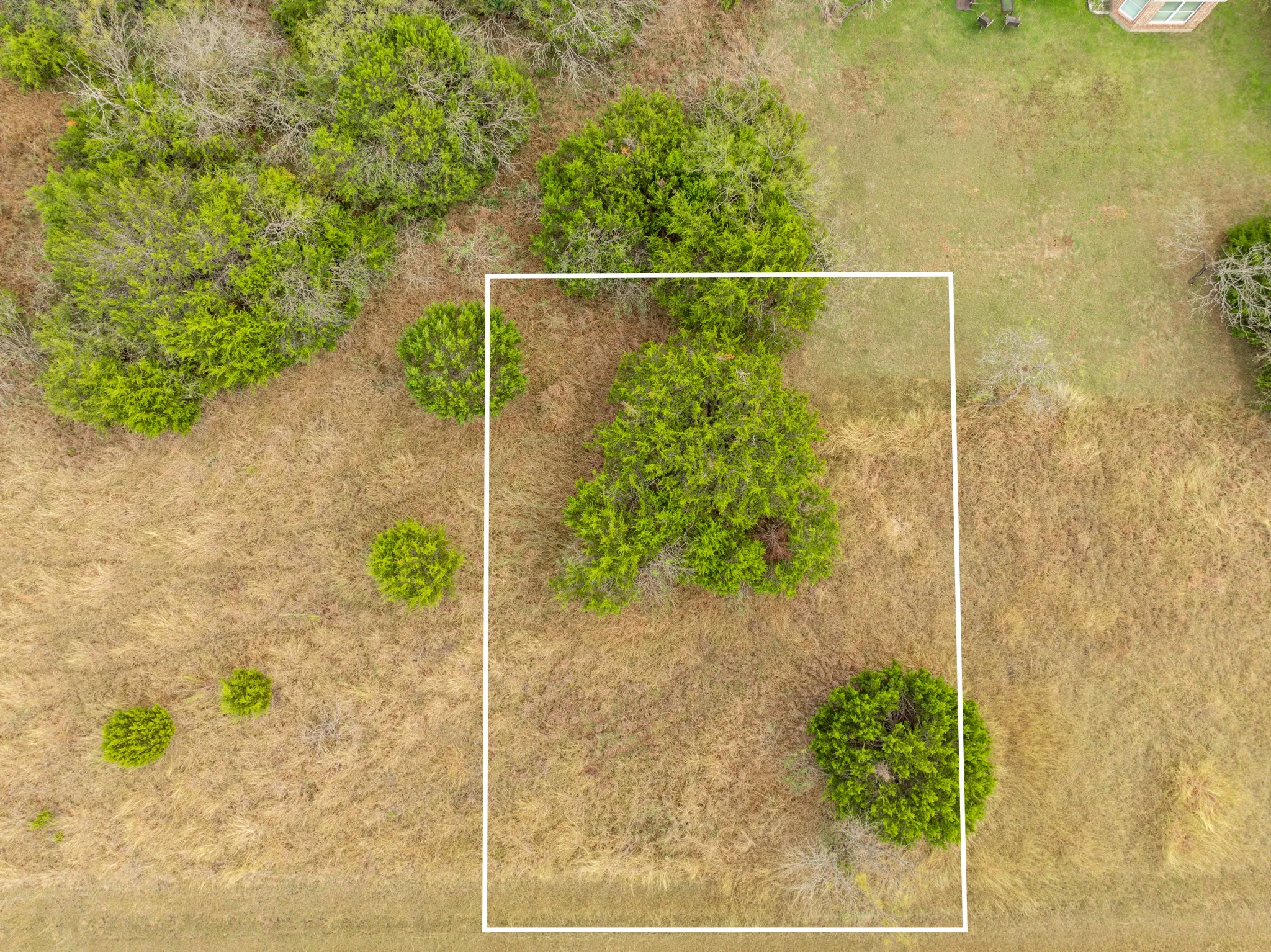 Aerial view of property and surrounding area featuring property parcel outlined