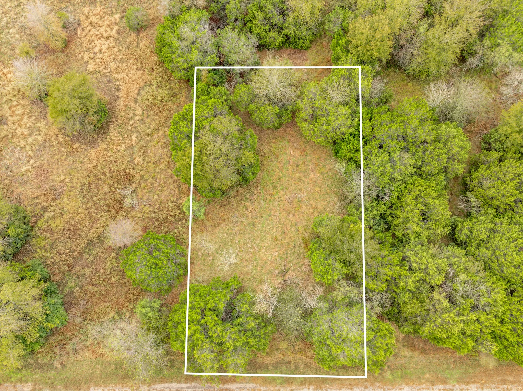 Aerial view of property and surrounding area with property parcel outlined