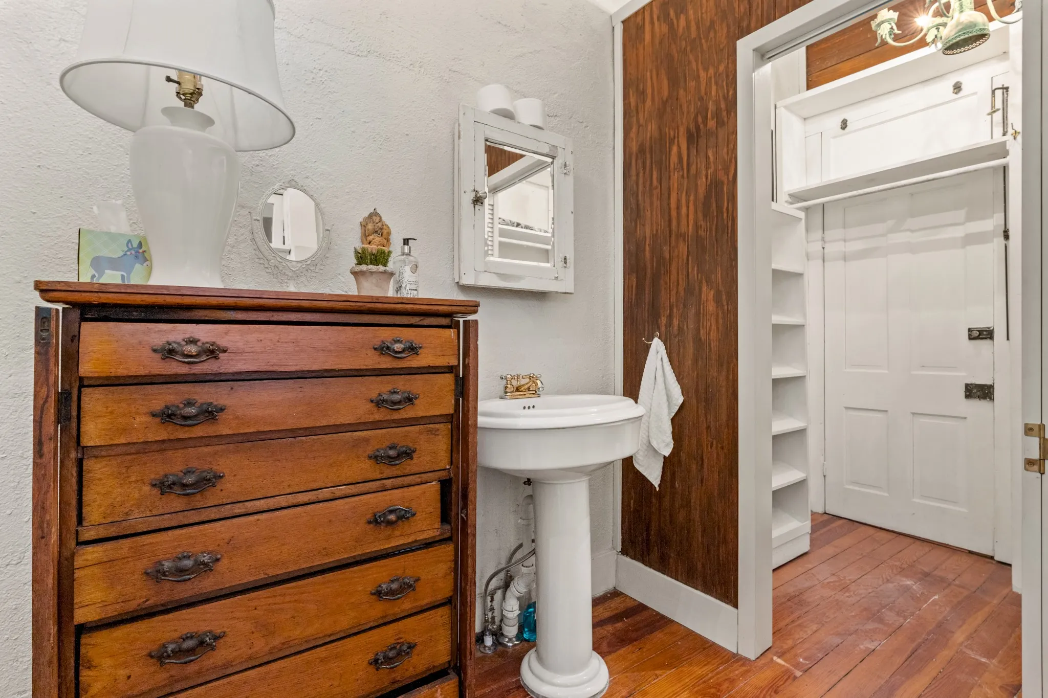 Full bathroom with hardwood / wood-style floors and a textured wall