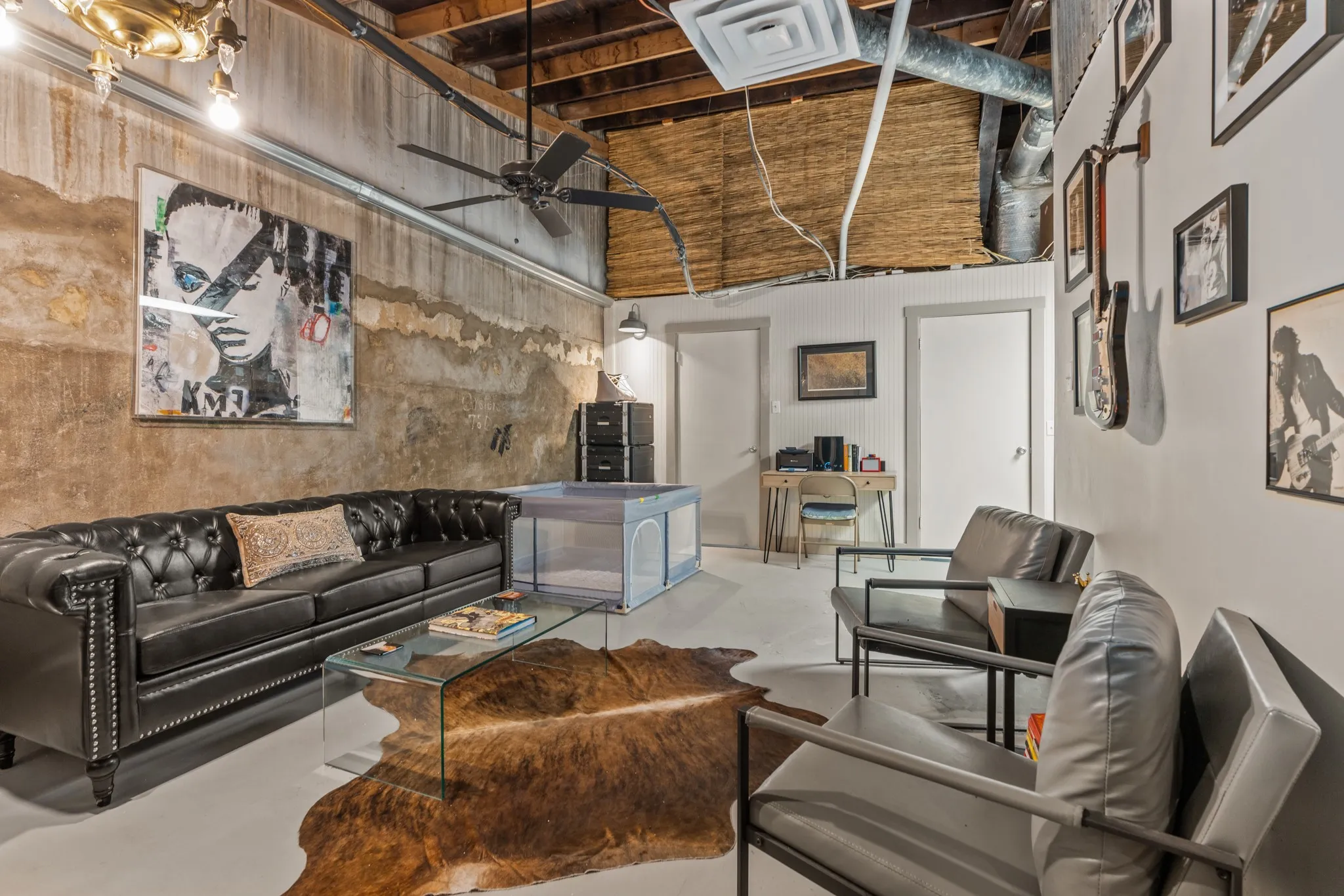 Living room with concrete floors, a high ceiling, and a ceiling fan
