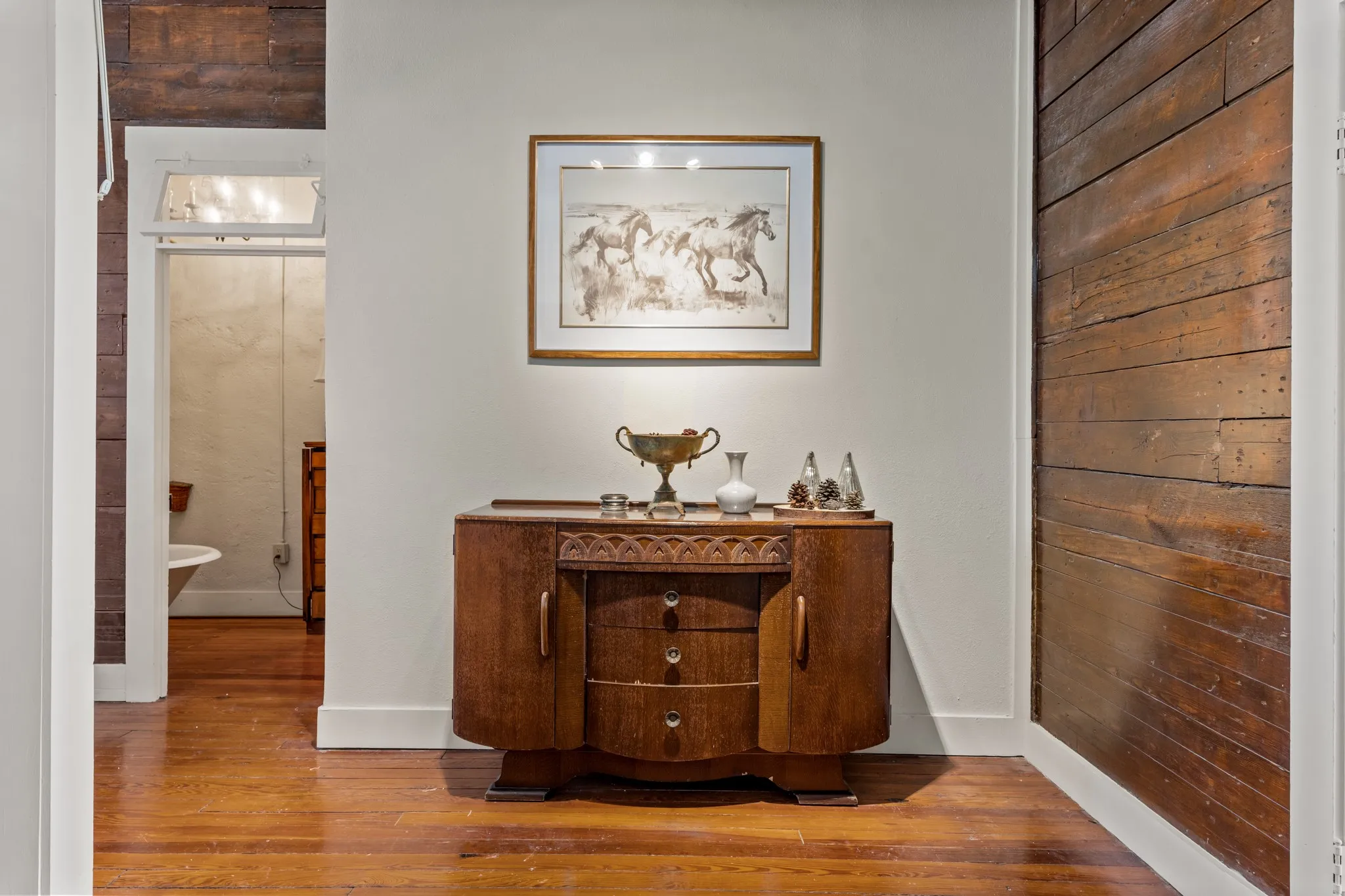 Corridor with wood-type flooring and baseboards