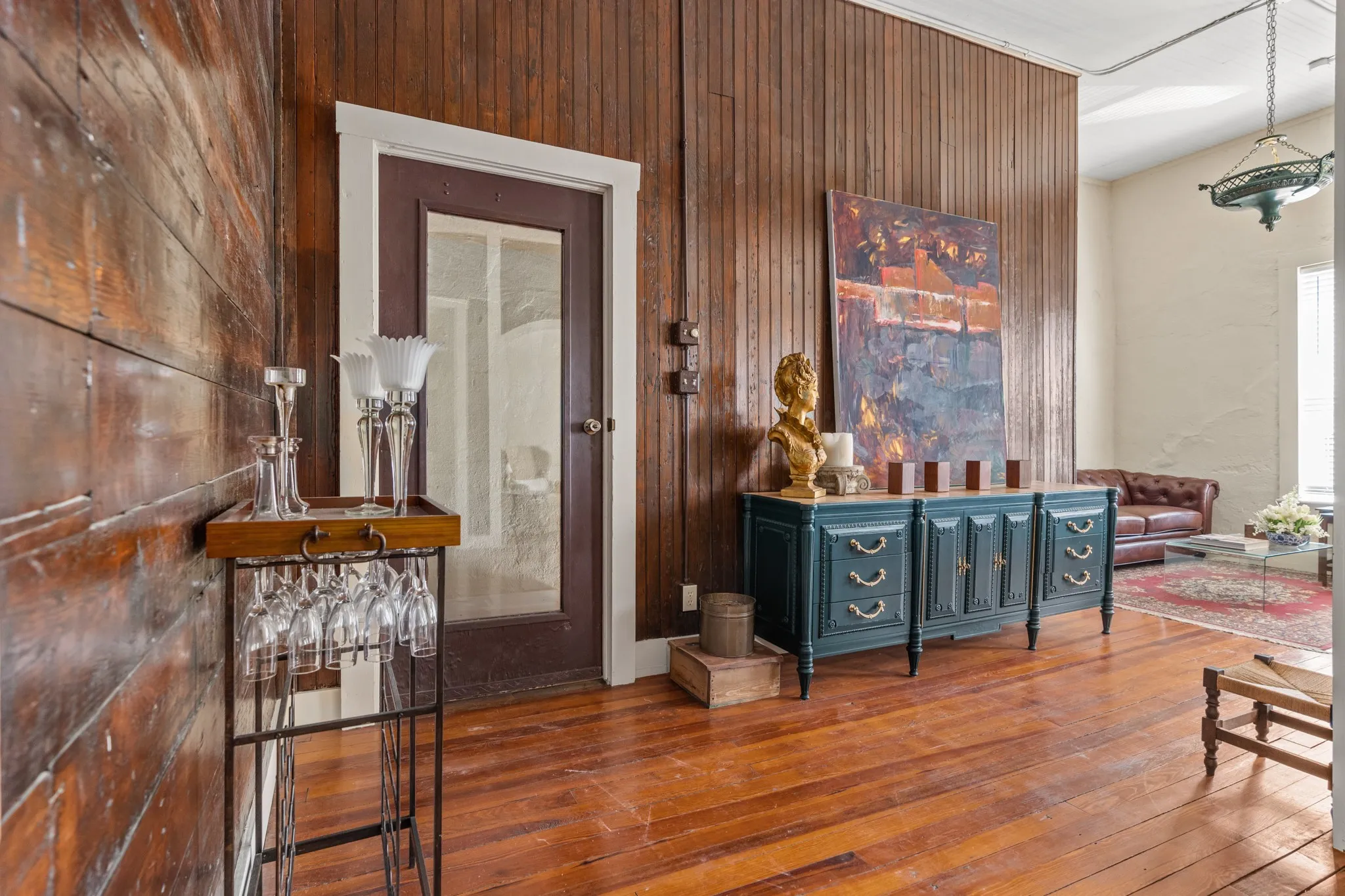 Corridor with wood-type flooring and wooden walls
