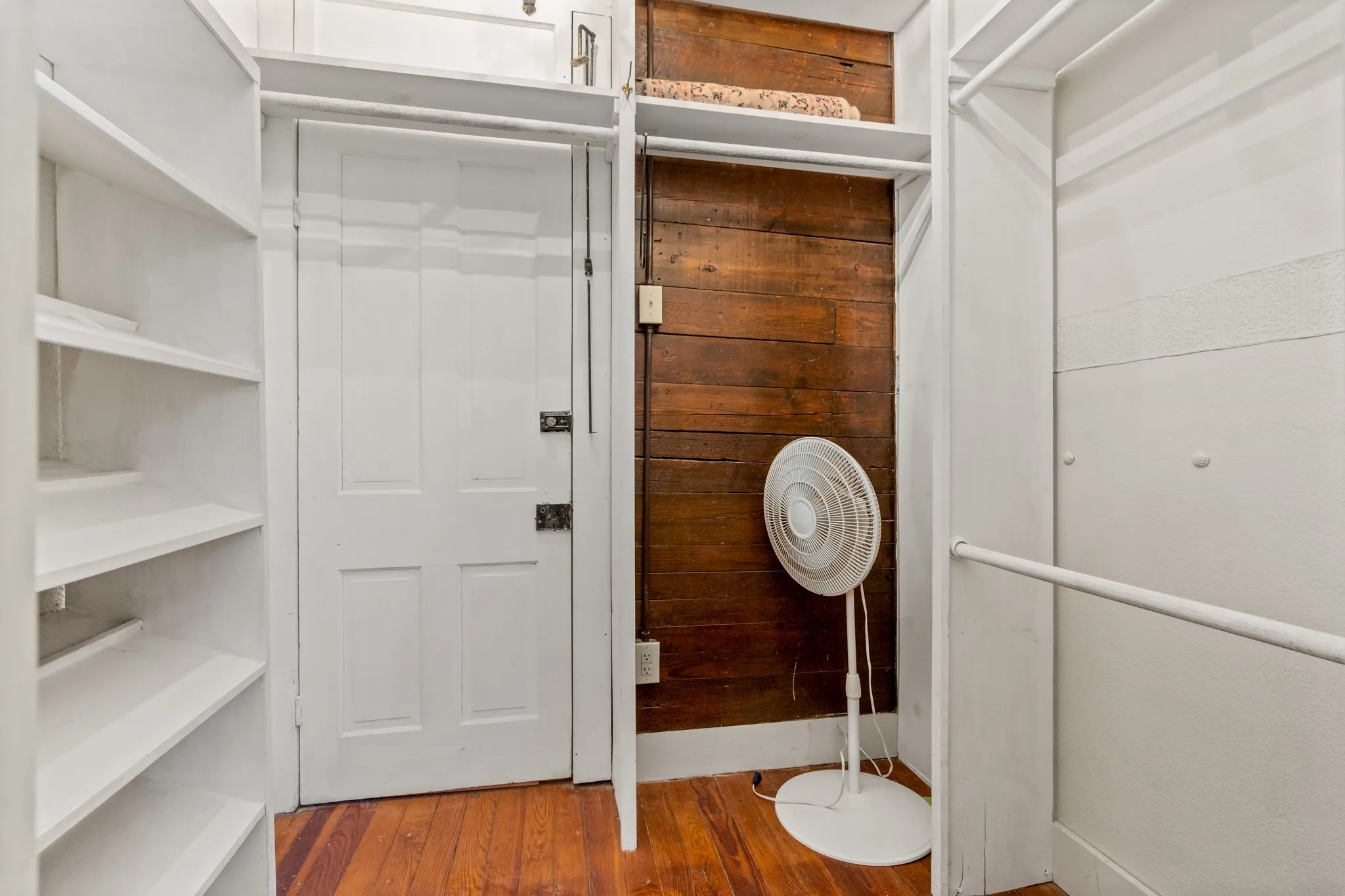Spacious closet featuring hardwood / wood-style flooring